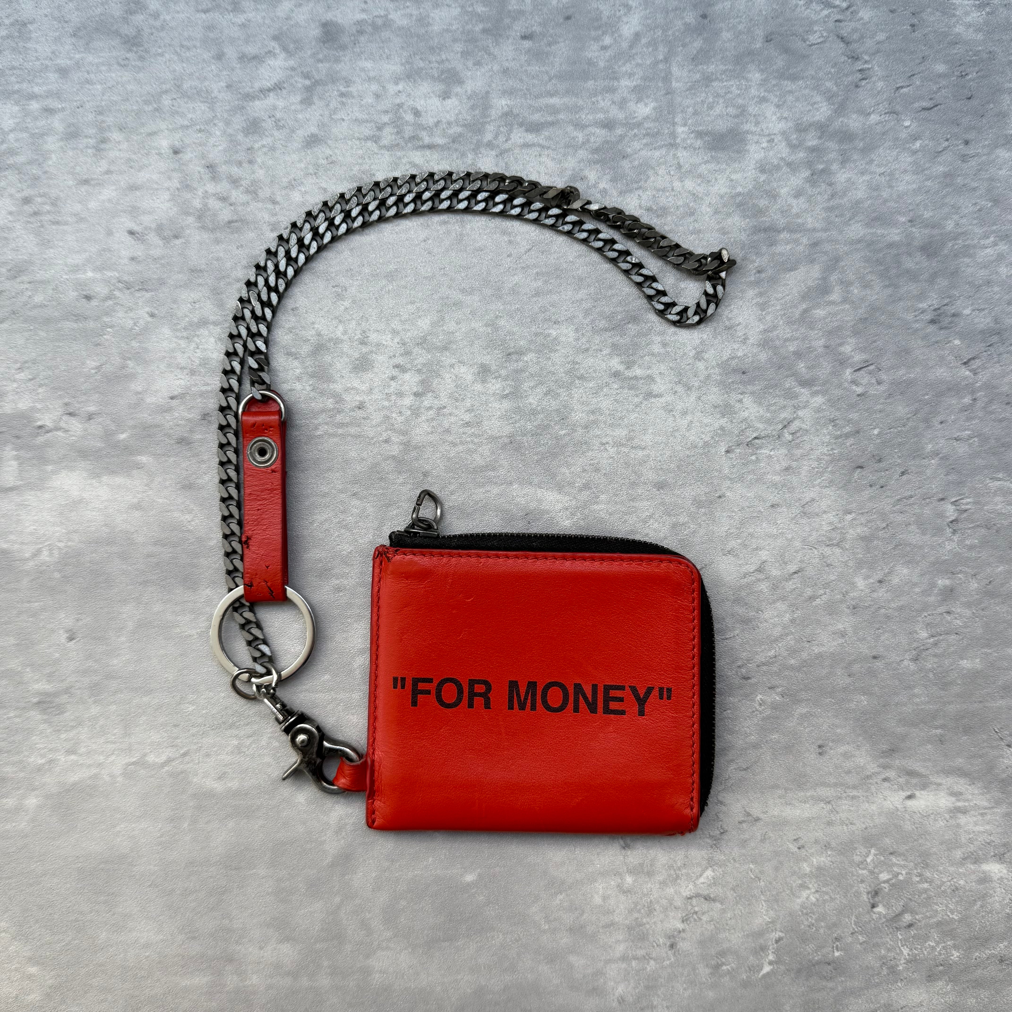 Off-White Quote Chain Wallet in orange leather with black ‘FOR MONEY’ print, zip closure, and silver-tone chain.