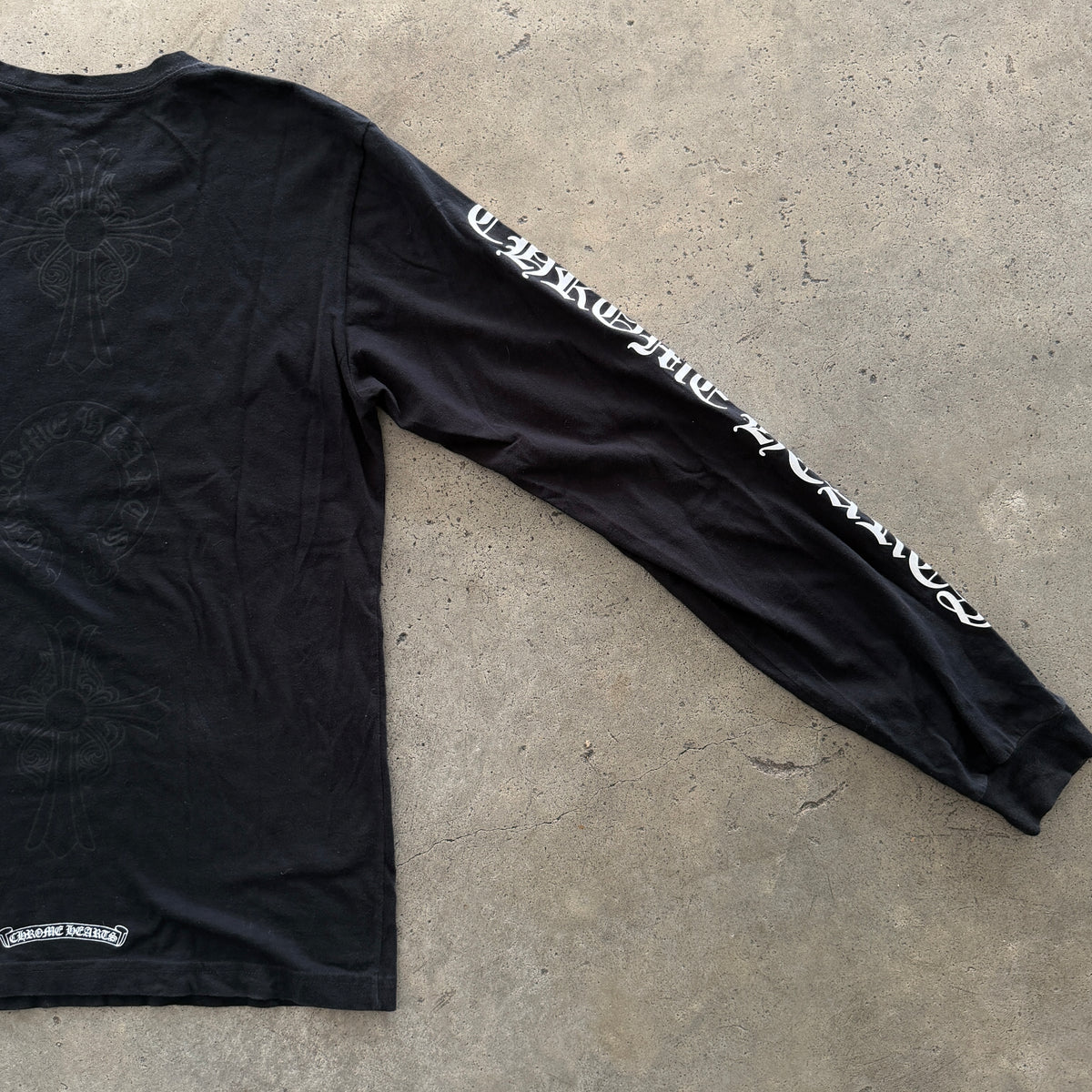 Chrome Hearts black long sleeve T-shirt with tonal cross chest pocket graphic and sleeve logo detail.