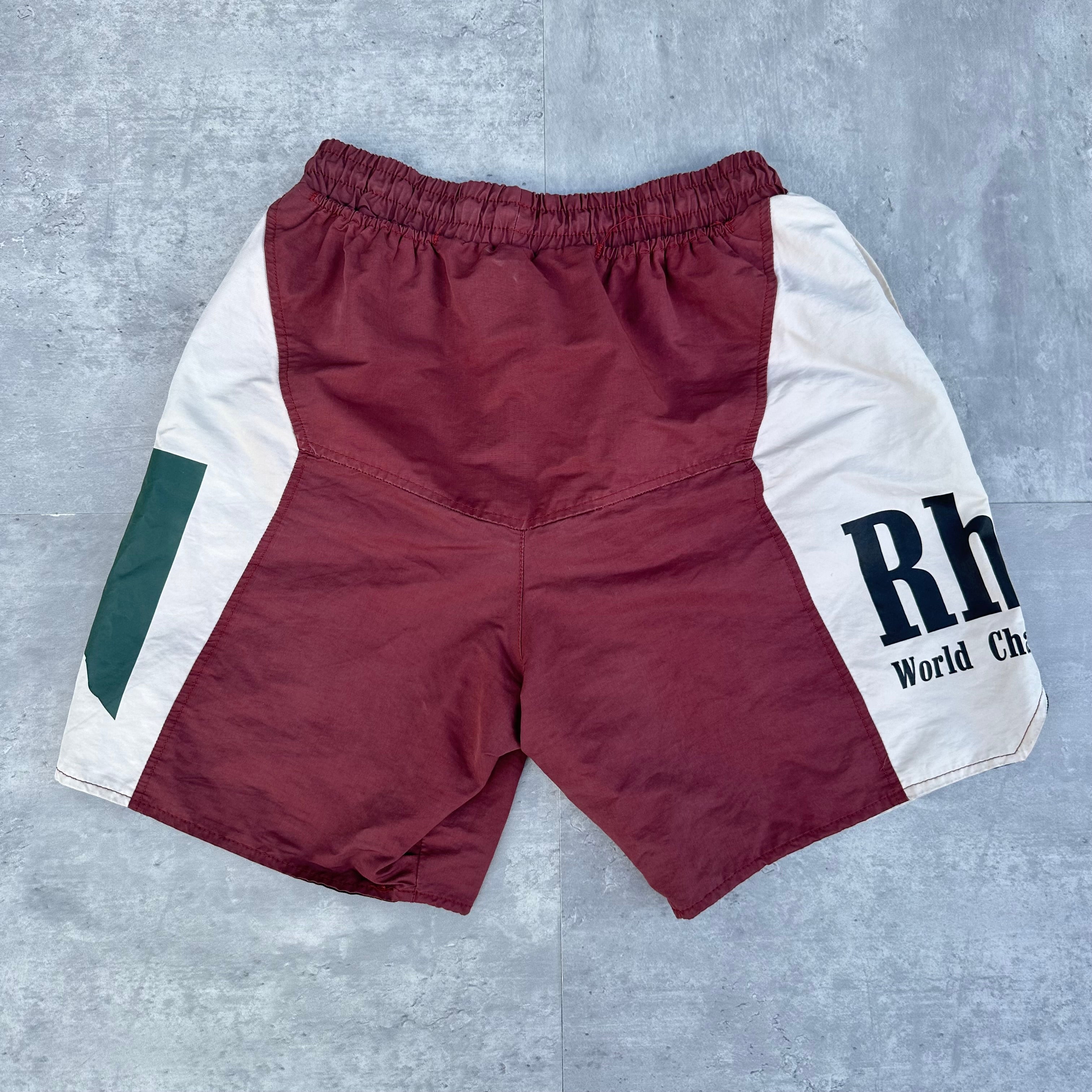 Rhude Panel Logo Shorts Maroon/White/Multi FW22, featuring championship print and moon graphic, with yellow drawstring and bold panel design.