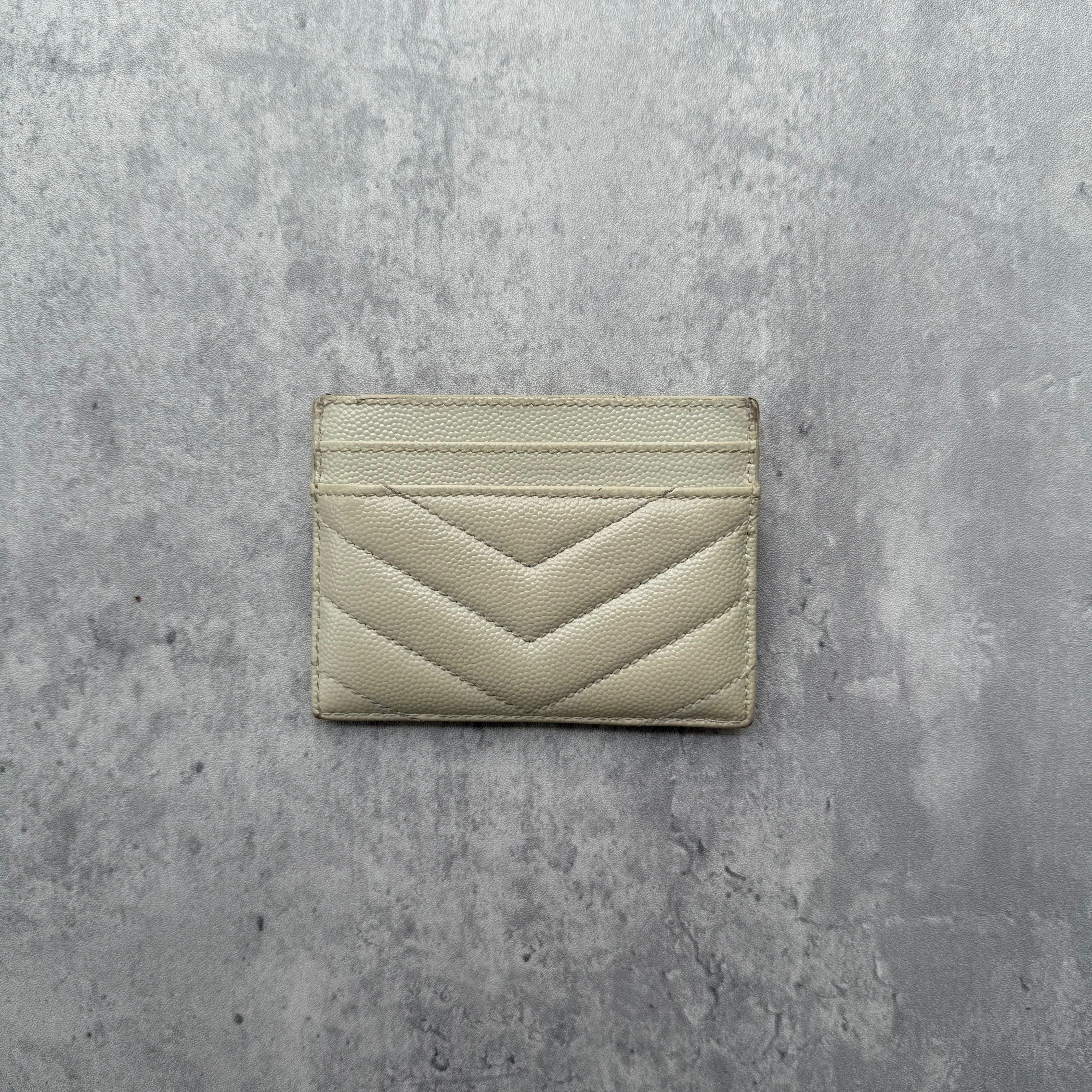 Saint Laurent Cassandre Matelassé Card Case in cream quilted leather with gold YSL logo and multiple card slots.