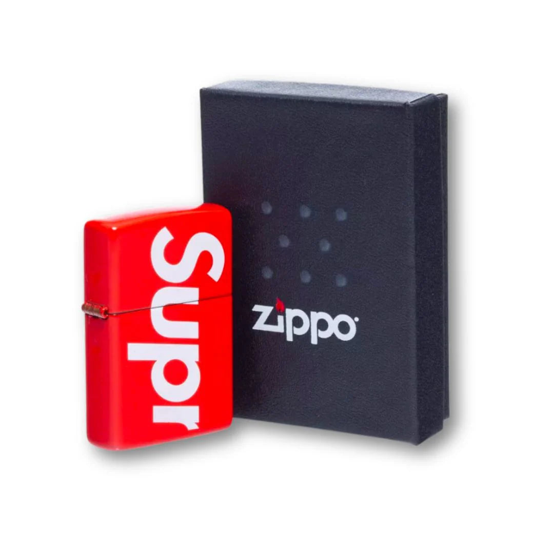 Supreme Logo Zippo Red, featuring a high-gloss metal casing, iconic white Supreme branding, and a classic windproof flip-top design.