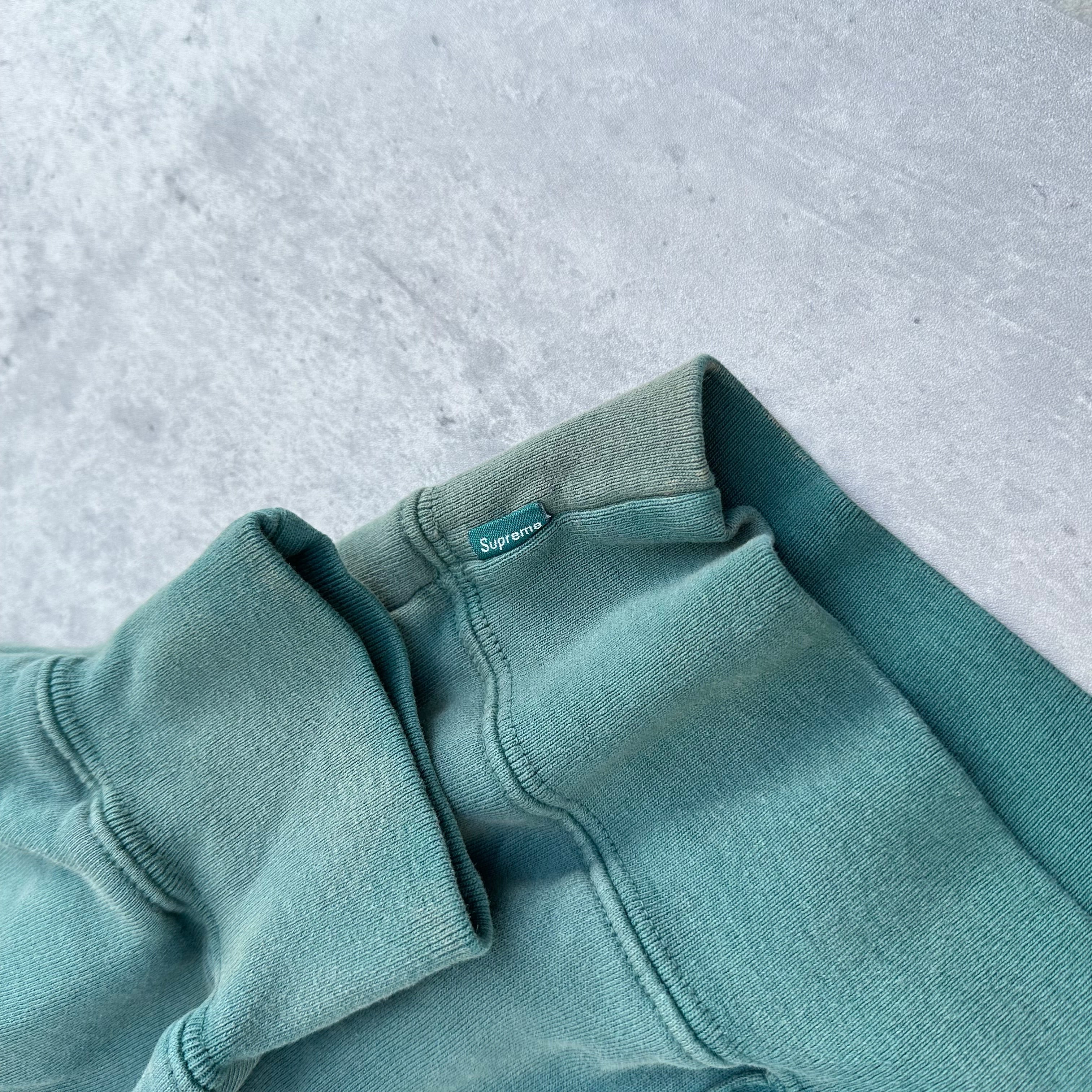 Supreme Overdyed S Logo Hoodie in washed teal, featuring tonal embroidered S on chest with kangaroo pocket and ribbed detailing
