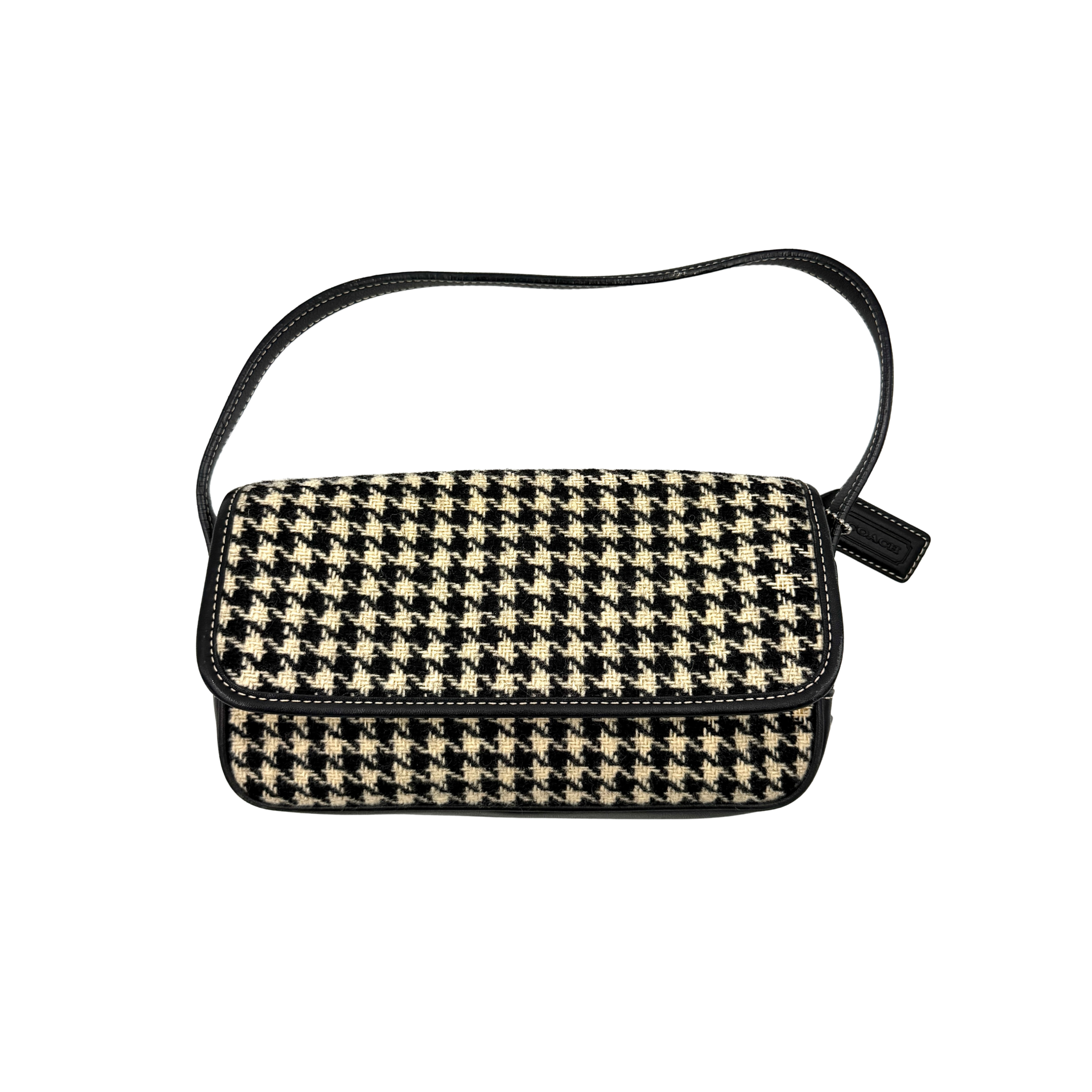 Coach Y2K shoulder bag with a bold black and cream houndstooth pattern and sleek leather trim.
