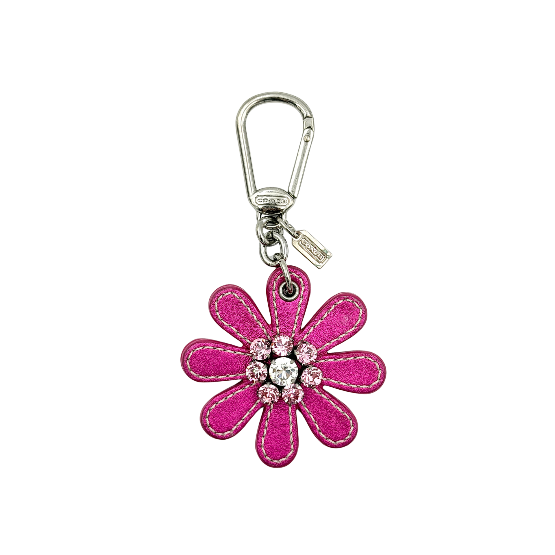 Coach Daisy Flow Bag Charm in magenta leather, featuring crystal accents and silver-tone hardware, styled with precise stitching.
