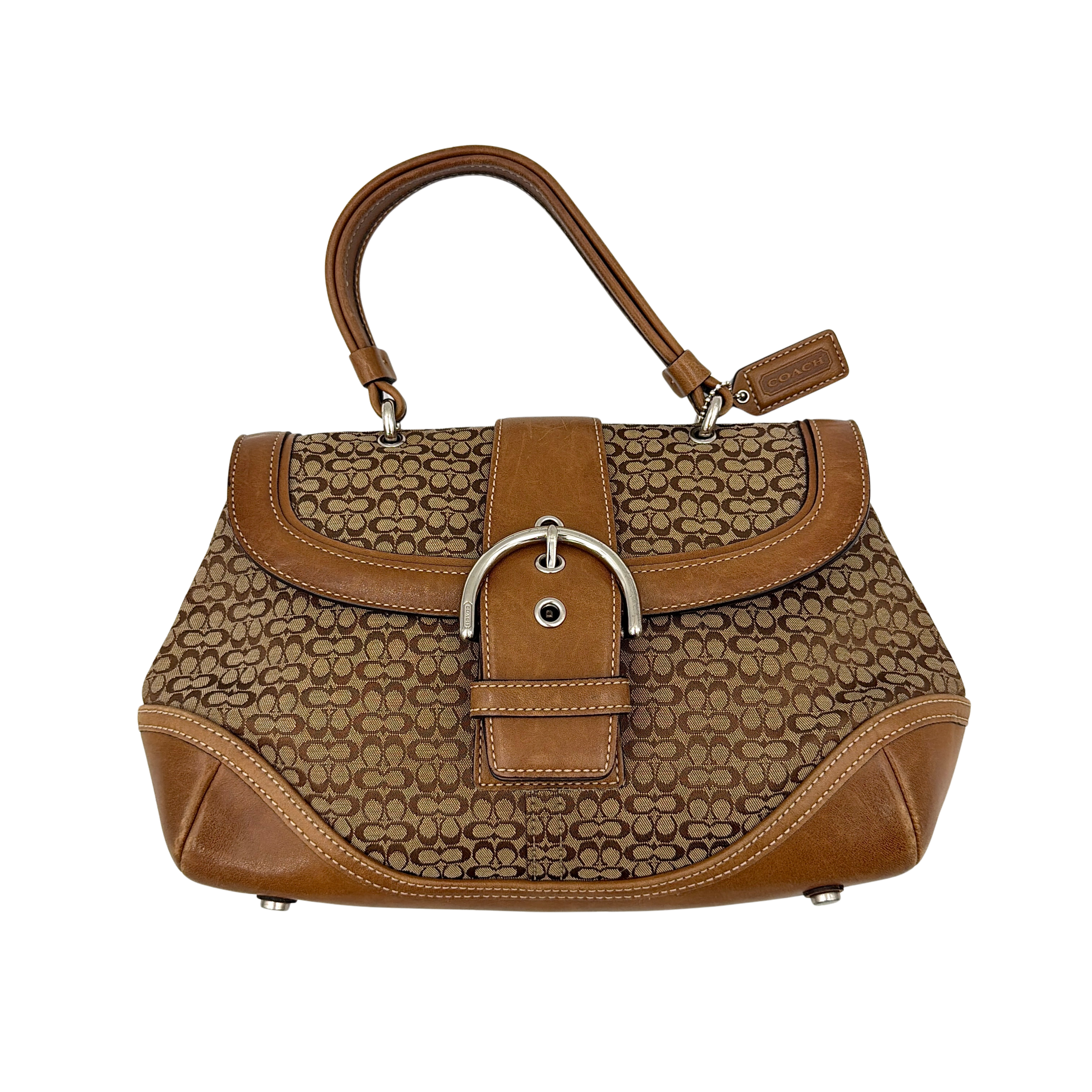Coach Soho Shoulder Bag in beige and tan monogram jacquard with caramel leather trim, featuring silver hardware and a signature buckle flap.