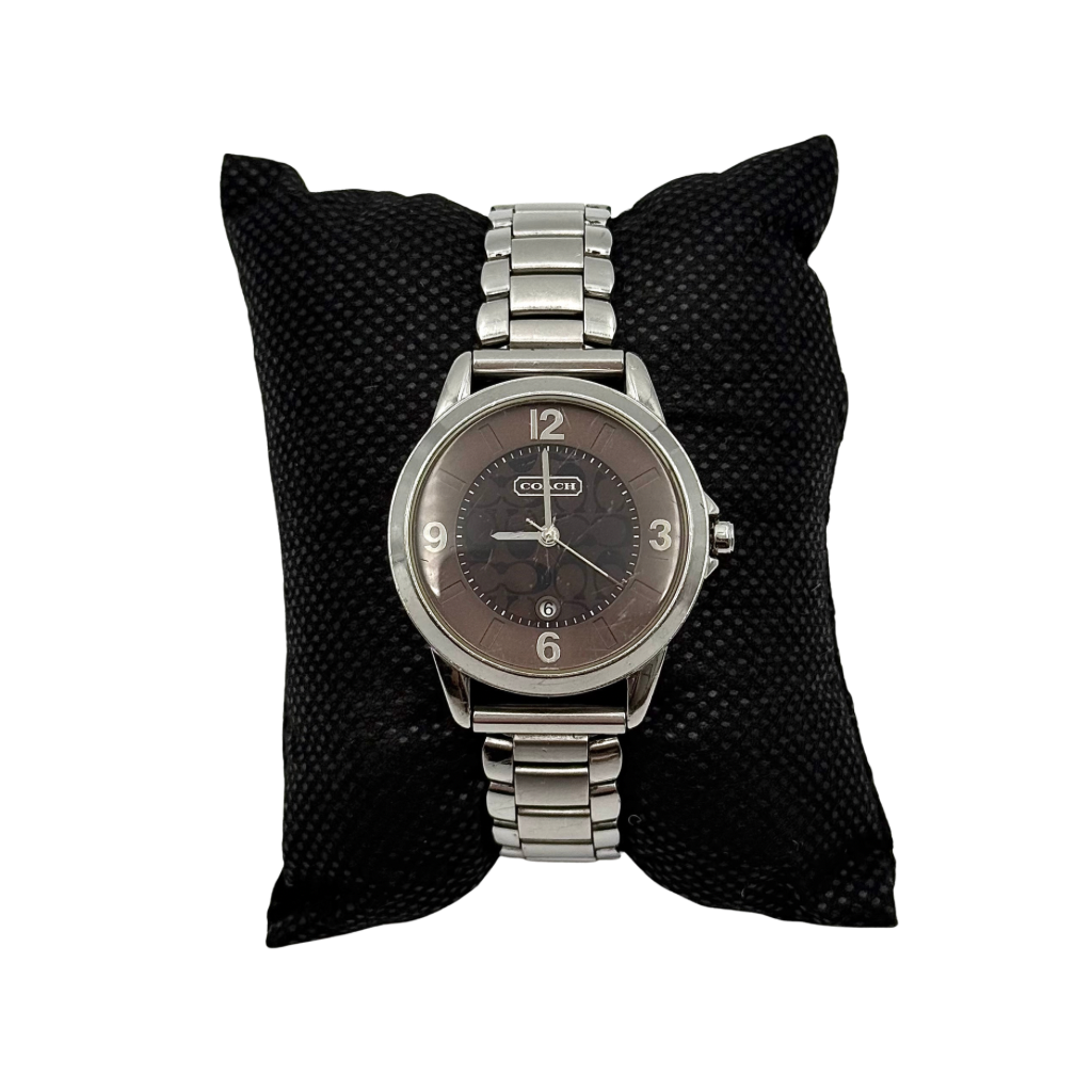 Coach CA.13.7.14.0431 stainless steel watch with brown dial and silver-tone bracelet, presented on a black cushion.