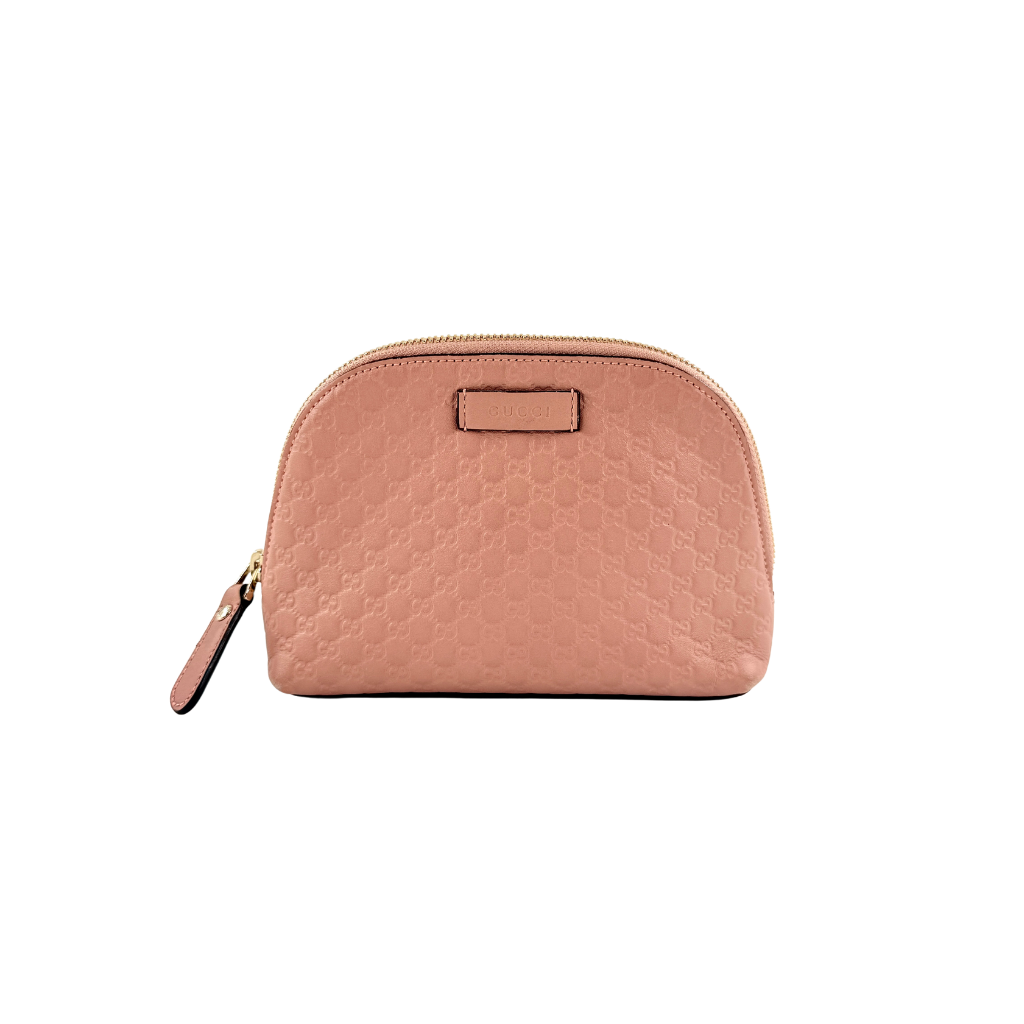 Gucci GG Monogram Guccissima cosmetic pouch in blush pink leather with signature embossed motif and gold-tone zip hardware.