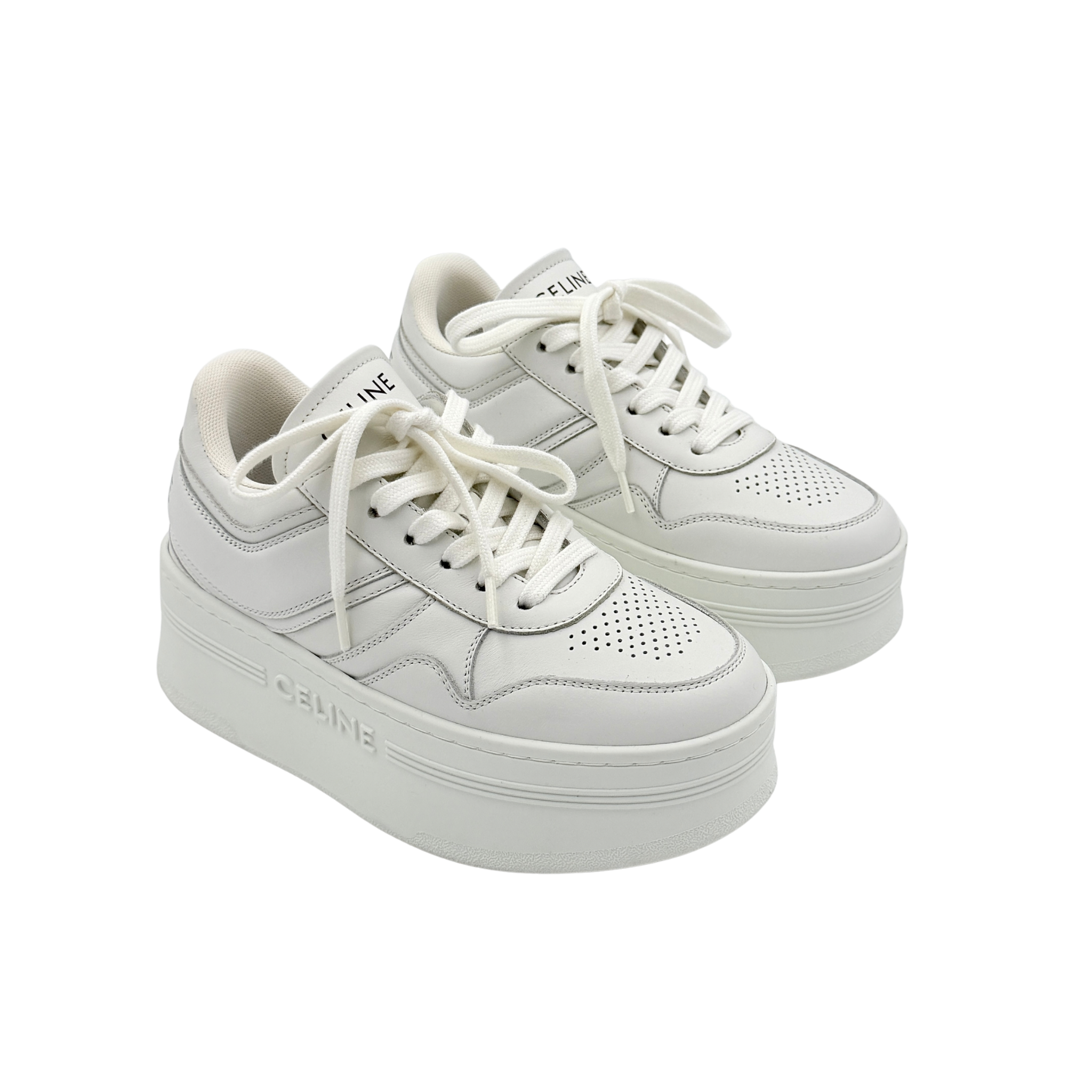Celine white leather block platform sneakers with bold embossed sole and lace-up front, displayed at a slight angle.