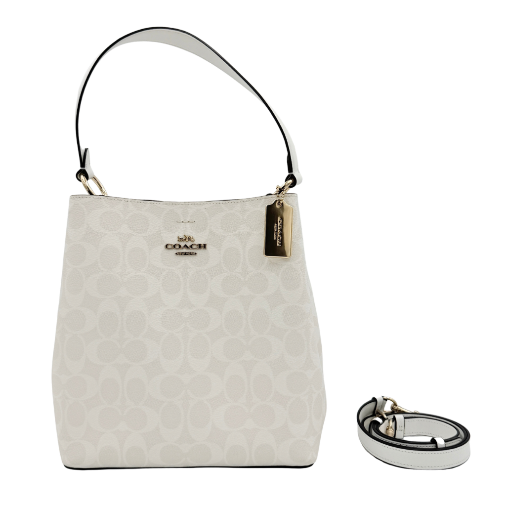 Coach Signature Town Bucket Shoulder Bag in white monogram canvas, shown with detachable strap and gold-tone hardware.