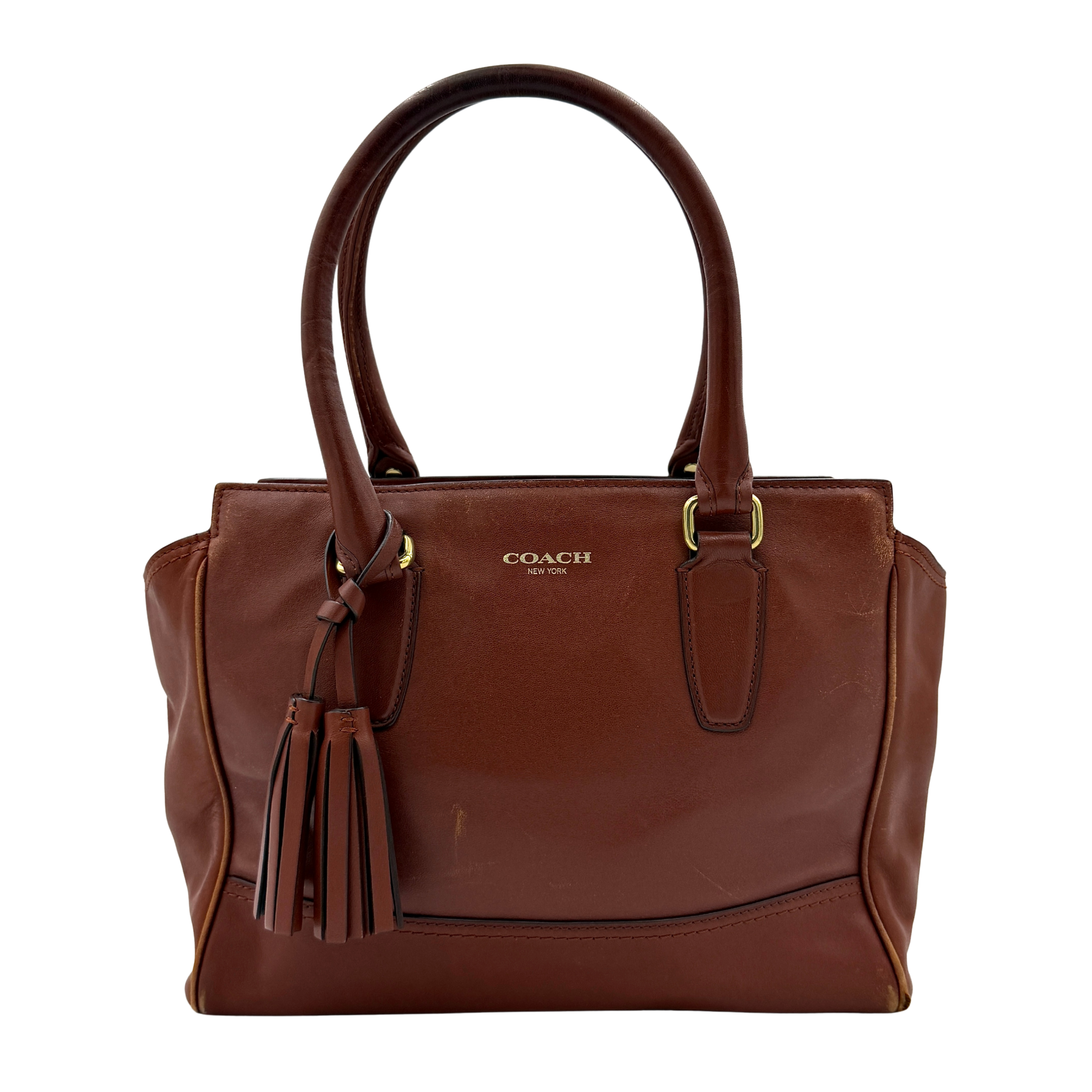 Coach Legacy Candace Carryall in smooth brown leather with gold hardware, rolled handles, and signature tassel accents.