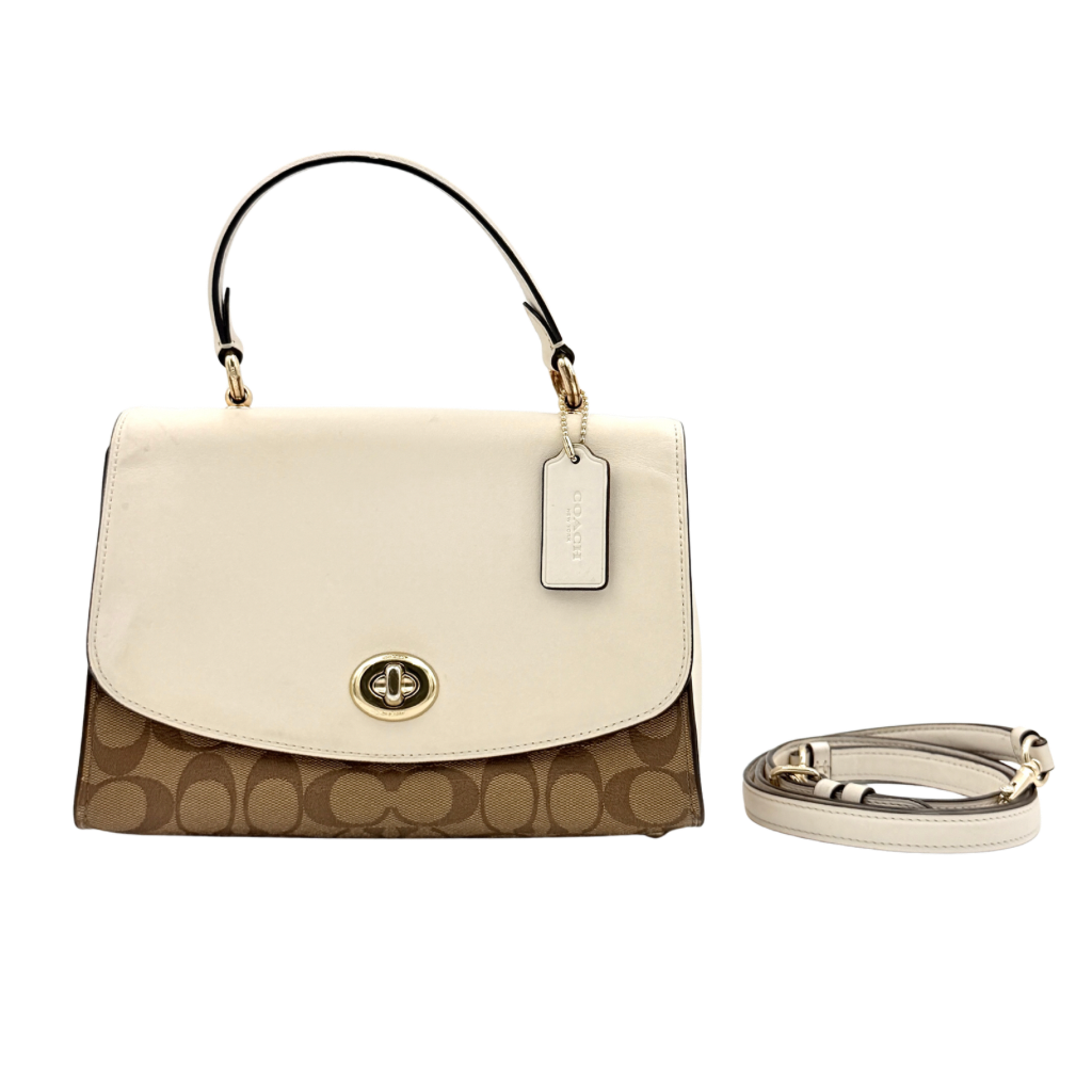 Coach Signature Tilly Top Handle Bag in beige and white with gold-tone hardware and detachable strap, displayed against a clean background.