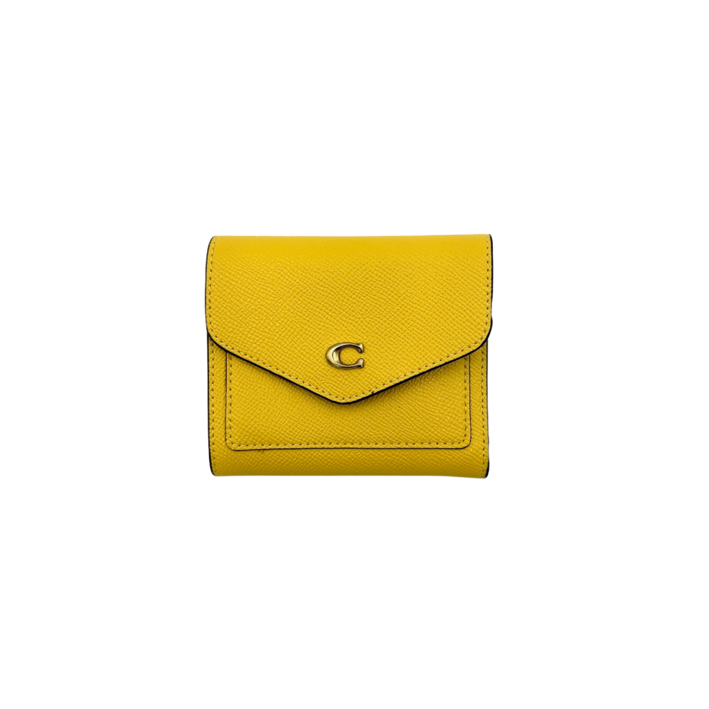 Coach Wyn Small Wallet in vibrant yellow leather with gold-tone 'C' detail on the envelope flap.