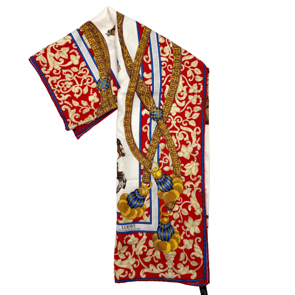 Loewe Velazquez Ecuestre silk scarf adorned with ornate red and gold baroque motifs and equestrian figures in rich multicolor.