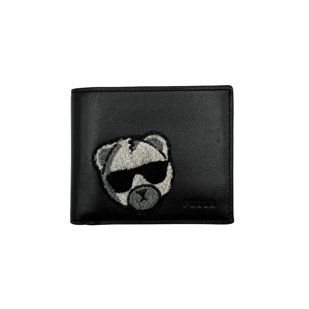Furla Man Cosmo black leather bifold wallet with a textured teddy bear patch on the front.