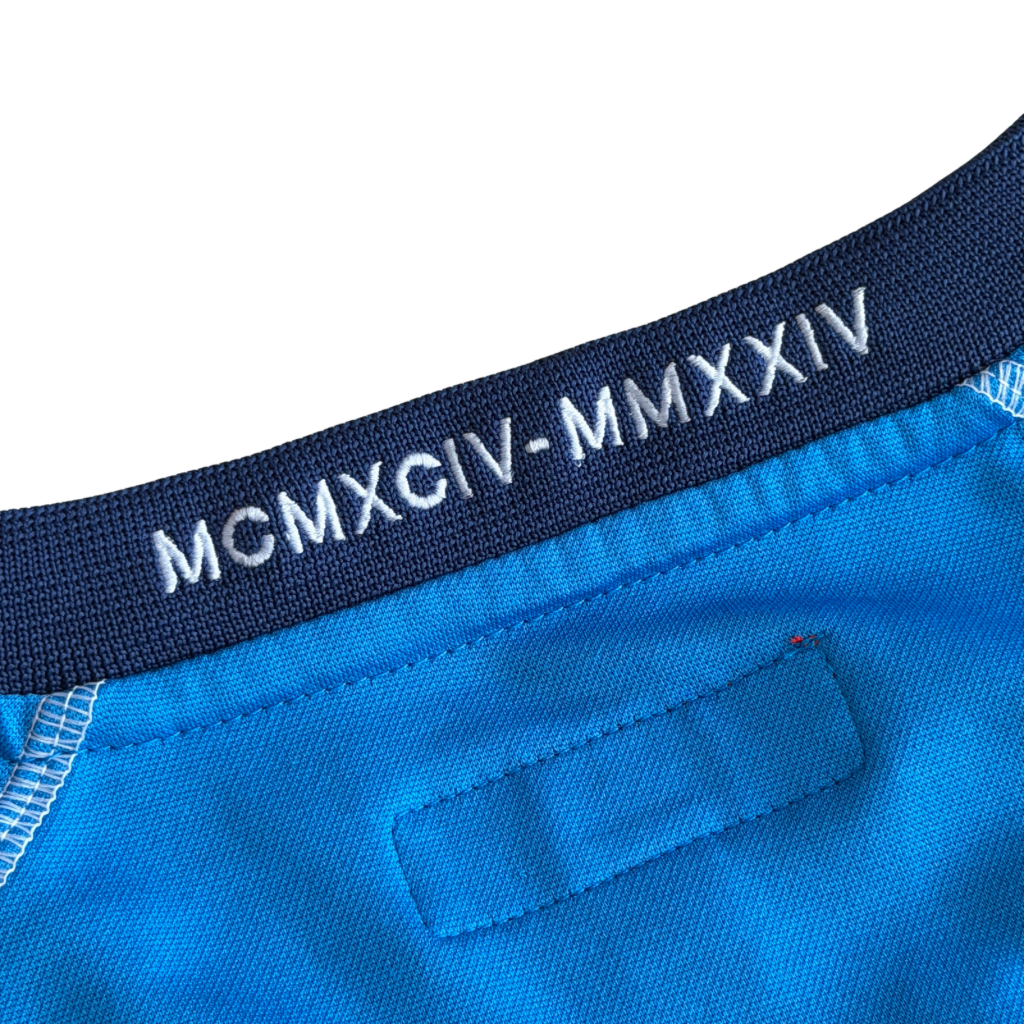 Supreme Jacquard Soccer Jersey in blue with front Supreme script and patch, navy side panels, and sporty detailing.