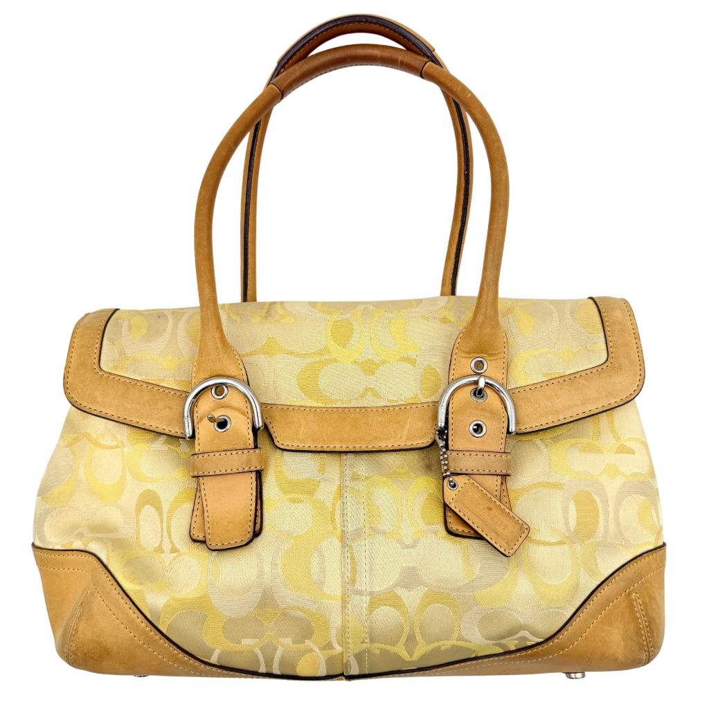 Coach Soho shoulder bag in yellow signature optic fabric with tan leather trim and silver hardware, shown with double handles.