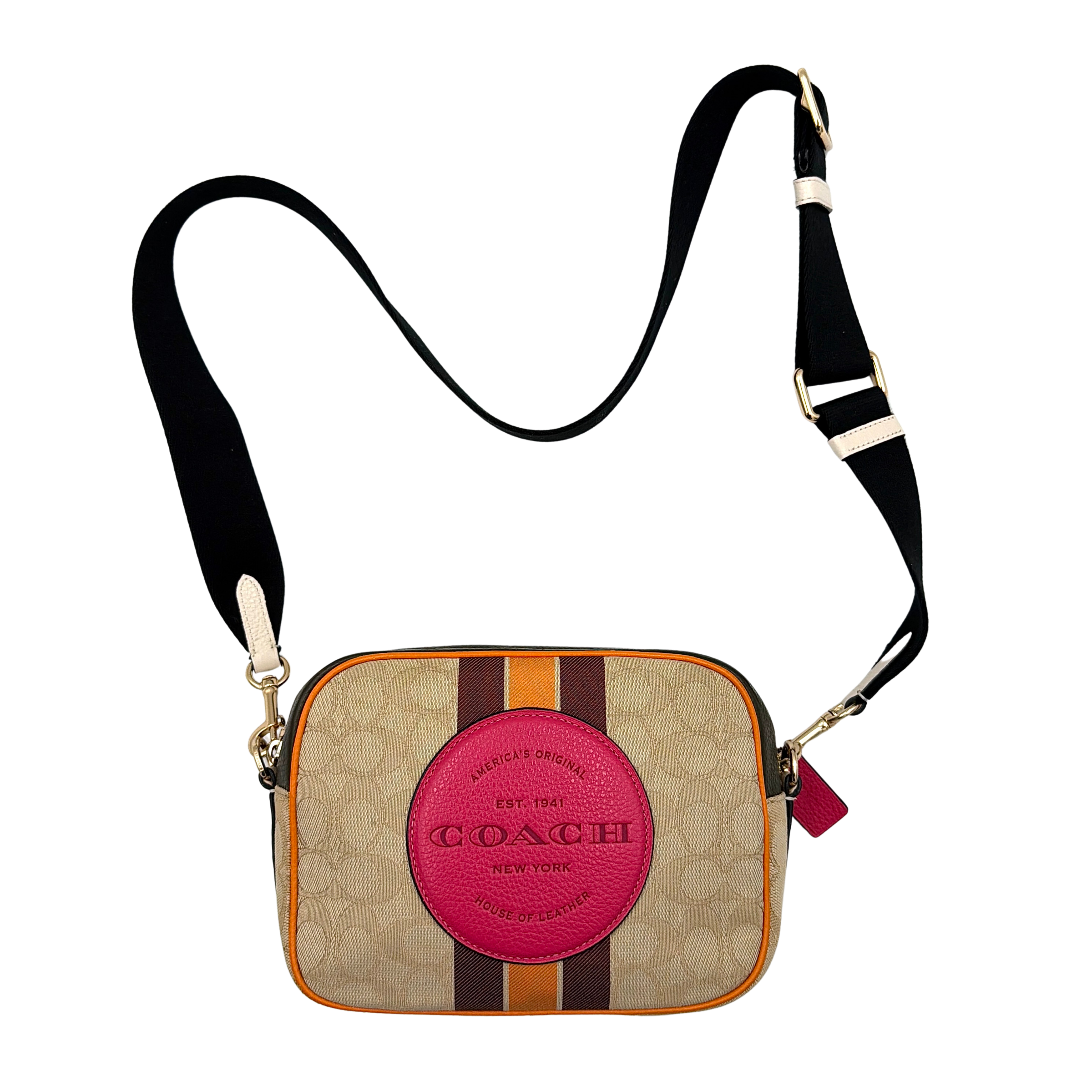 Coach Signature Dempsey Camera Bag in monogram canvas with bold pink logo patch, orange stripes, and wide black strap.