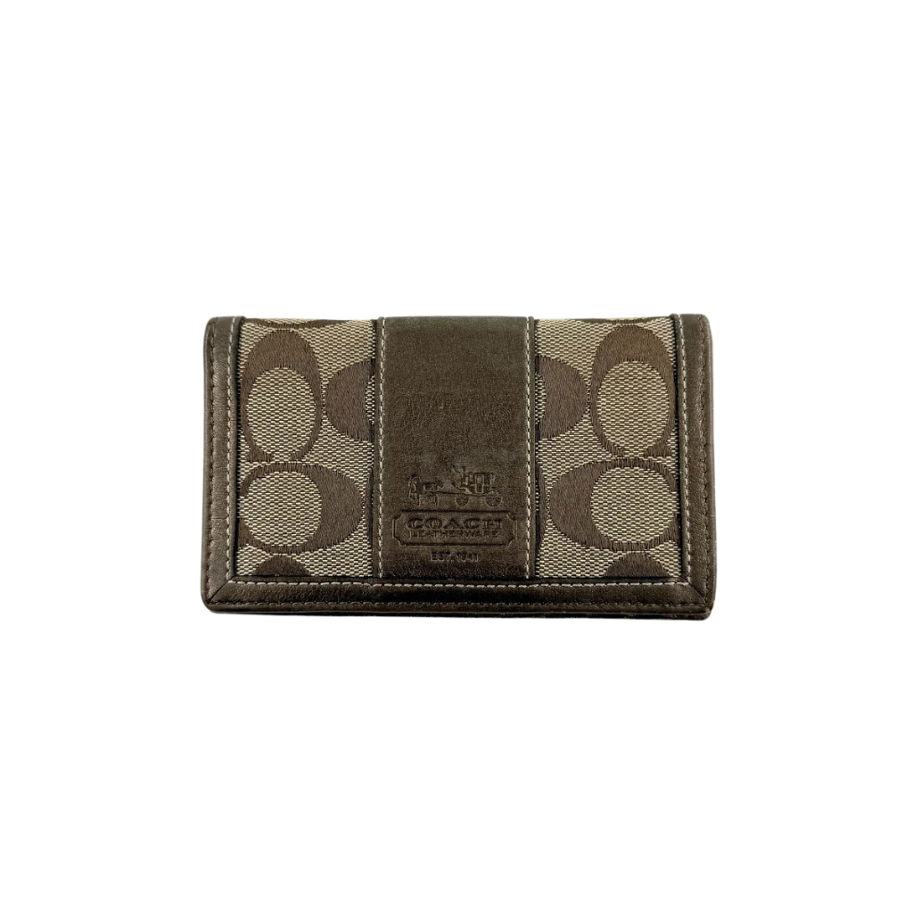 Coach Signature Stripe Snap Wallet in brown jacquard canvas with leather trim and embossed logo, shown against a white background.