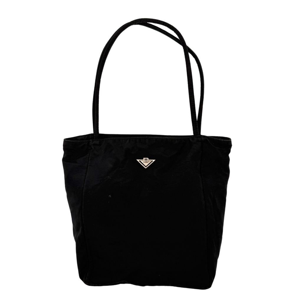 Bottega Veneta black nylon tote with structured double handles and a pale gold-tone logo plaque at the front.
