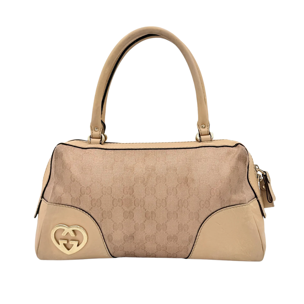 Gucci GG Monogram Heart Lovely Boston Bag in beige and pink with gold heart logo and double handles, displayed against a plain background.