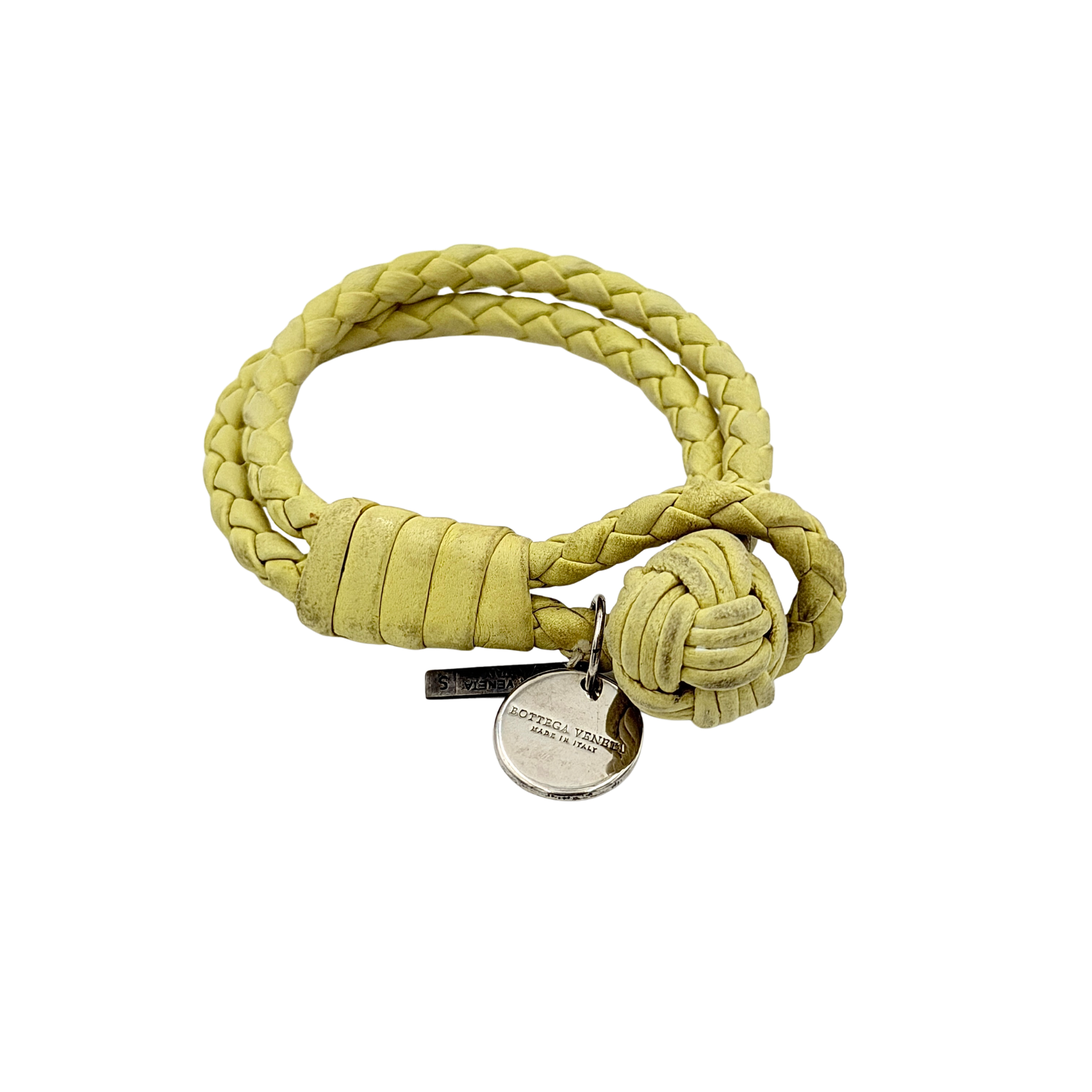 A braided pastel yellow Bottega Veneta Intrecciato leather bracelet with signature knot closure and engraved silver-tone tags.