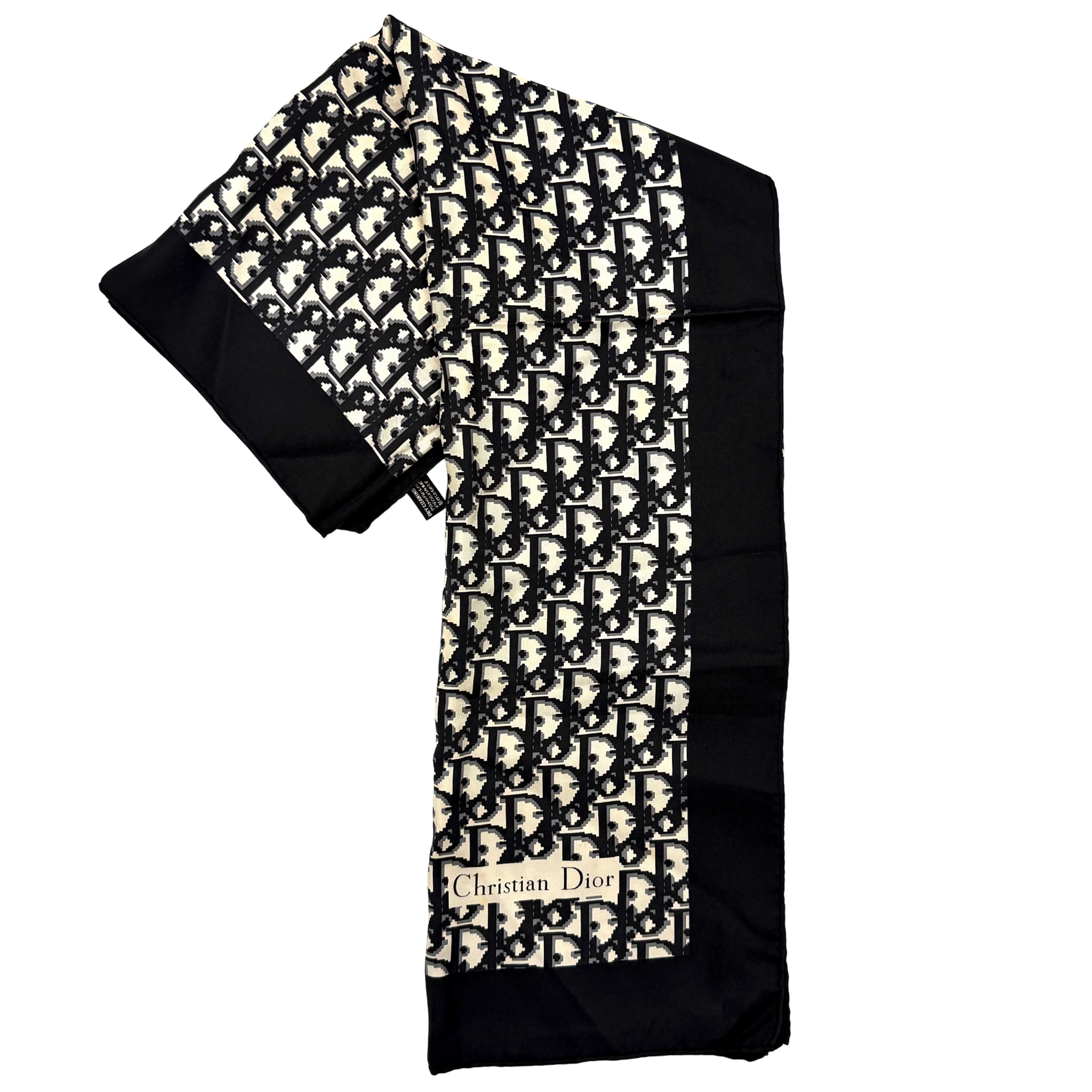 Dior monogram silk scarf in black and cream with graphic logo pattern and bold black border.