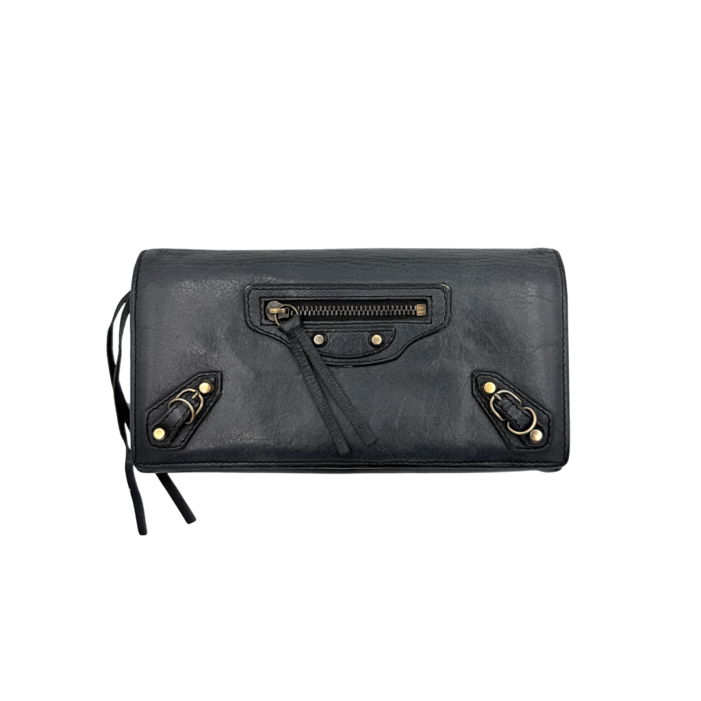 Balenciaga Agneau Leather Wallet in black with signature brass hardware and front zip detail, presented against a white background.