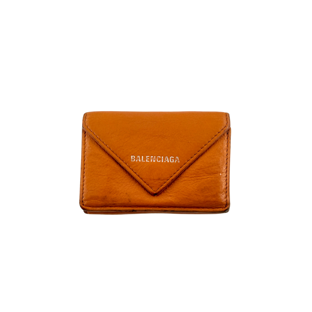 Balenciaga Papier Mini Wallet in vibrant orange grained leather, showcasing its envelope-style flap and silver logo detail.