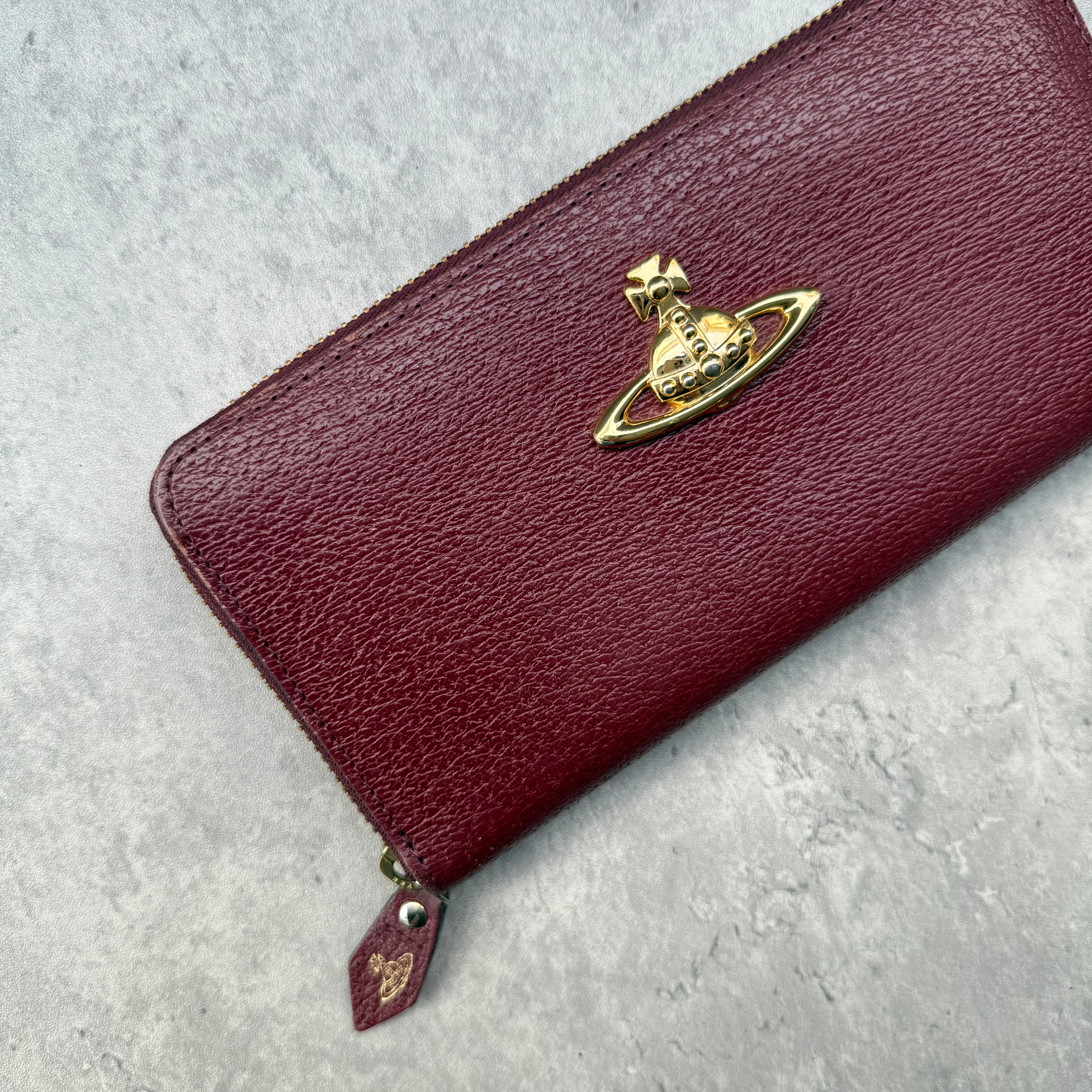 Vivienne Westwood Orb Long Wallet in maroon leather with tartan Seditionaries interior, gold-tone orb emblem, and zip-around closure