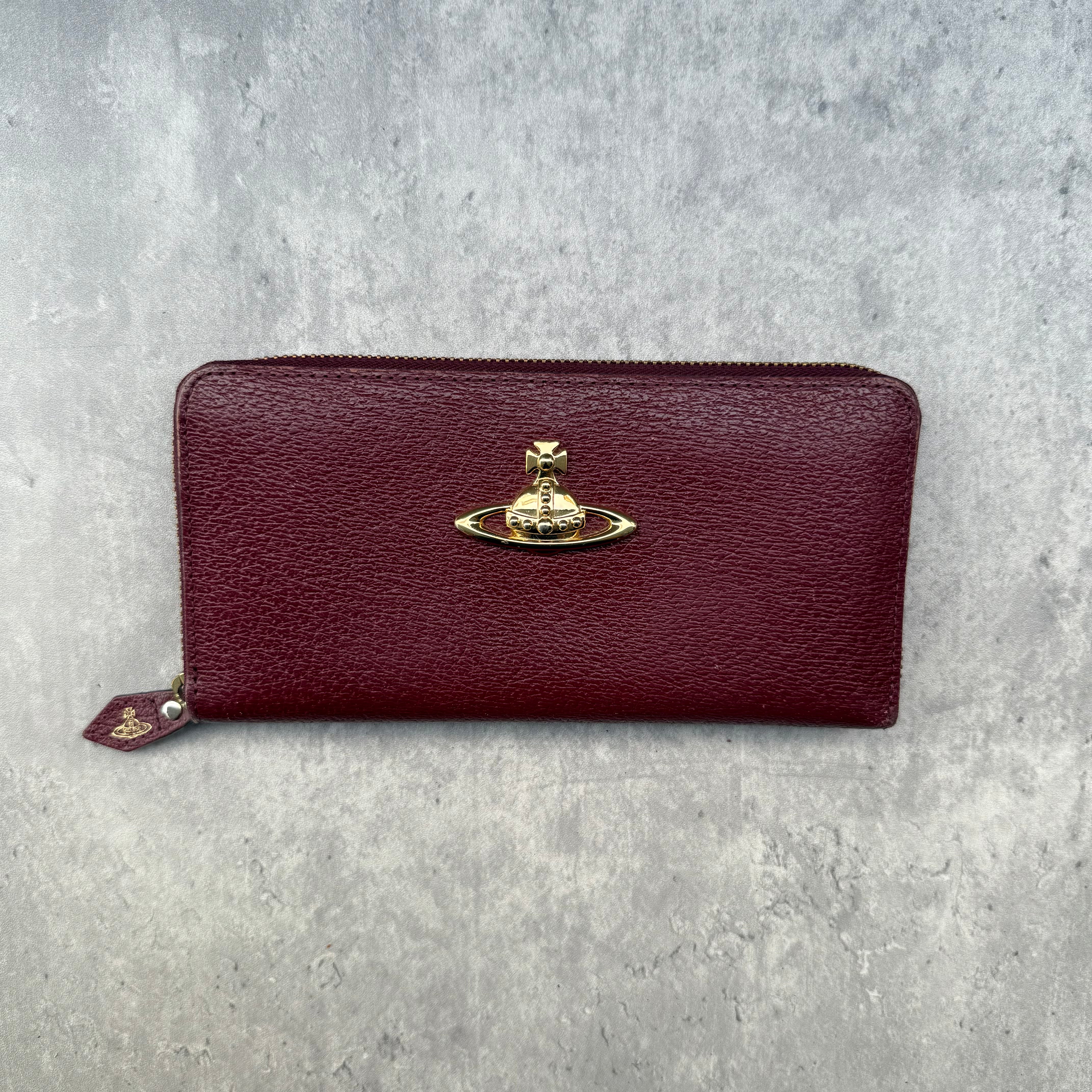 Vivienne Westwood Orb Long Wallet in maroon leather with tartan Seditionaries interior, gold-tone orb emblem, and zip-around closure