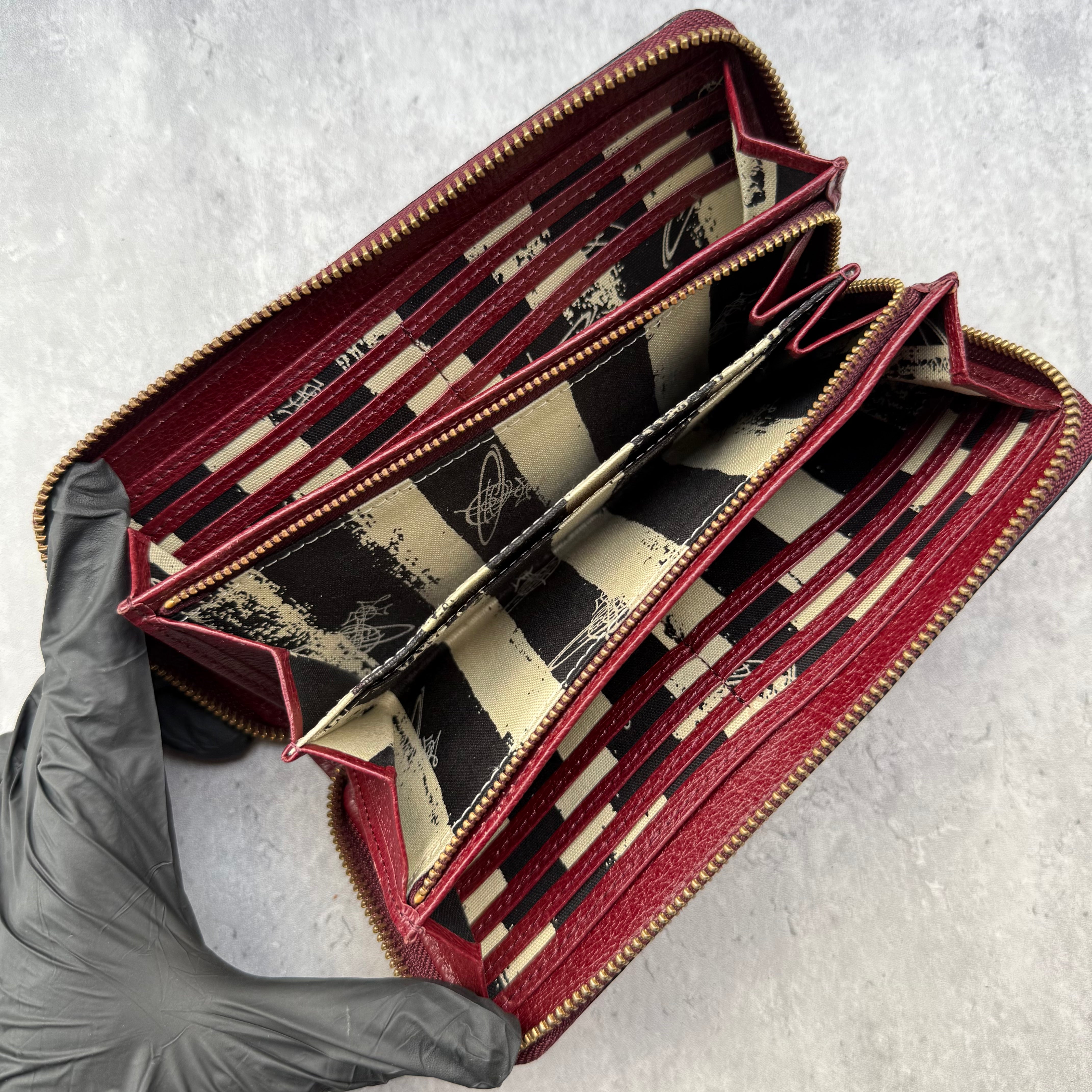Vivienne Westwood Orb Long Wallet in maroon leather with tartan Seditionaries interior, gold-tone orb emblem, and zip-around closure