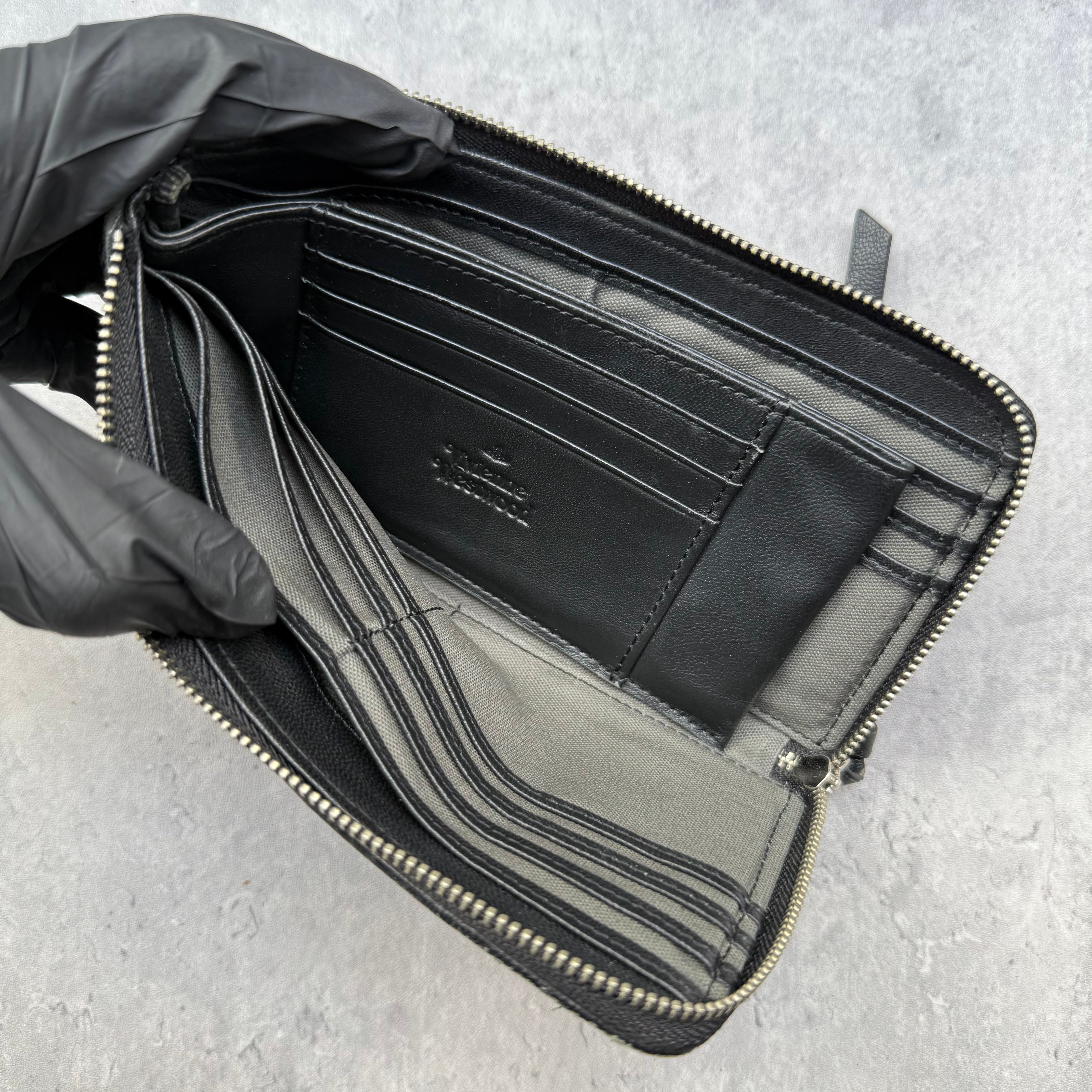 Vivienne Westwood Quilted Orb Long Zipper Wallet in black leather with zip-around closure and embossed orb motif