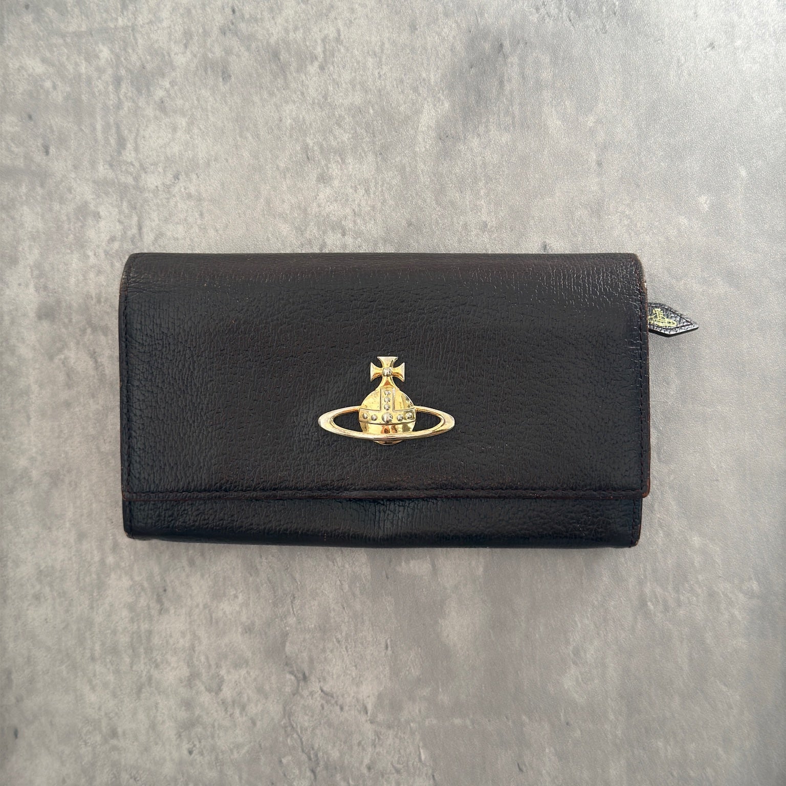 Vivienne Westwood Signature Orb Bi-fold Long Wallet in Black Leather with Gold-Tone Hardware and Multiple Interior Compartments.