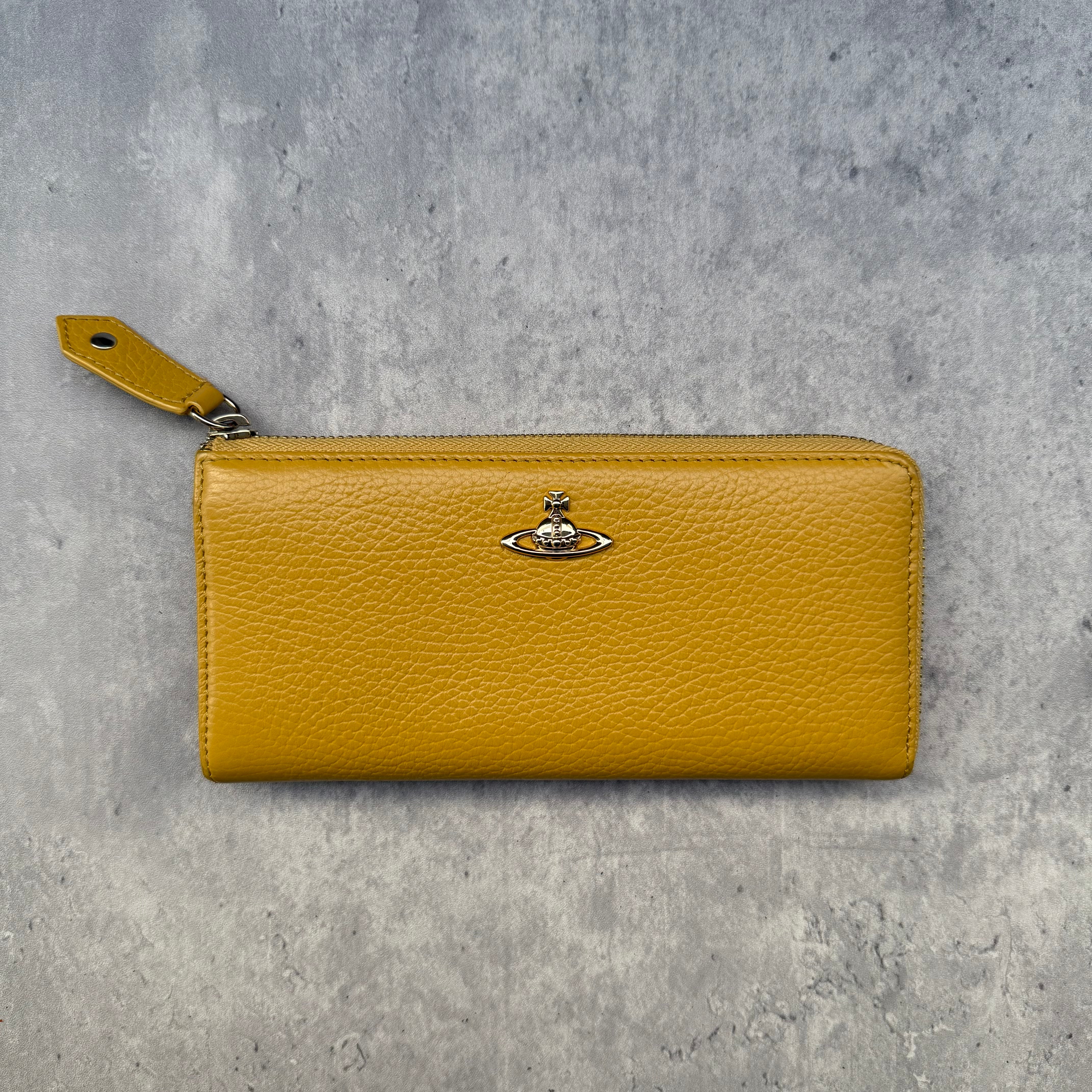 Vivienne Westwood Signature Orb Long Wallet in Yellow grained leather with silver-tone Orb hardware and zip-around design.