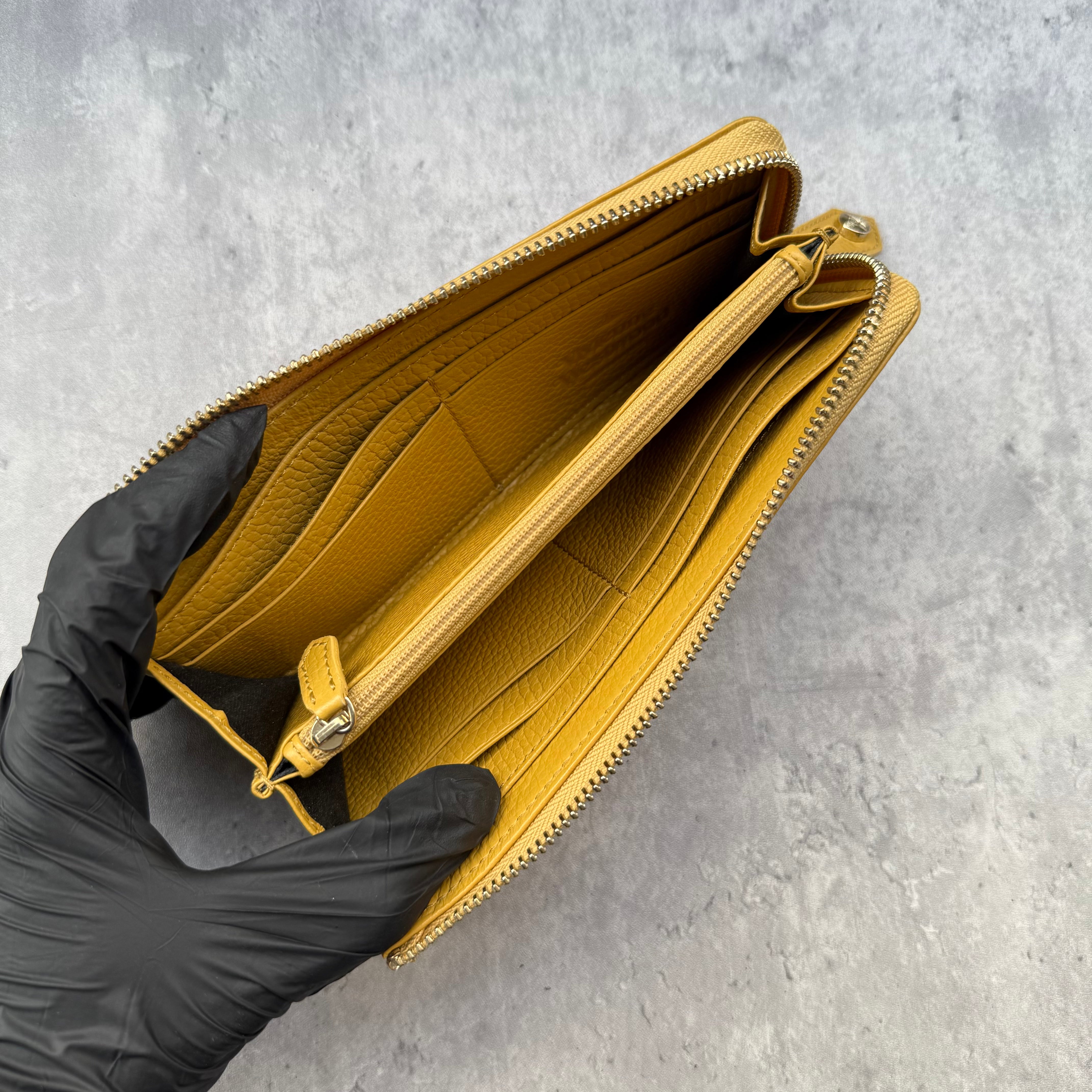 Vivienne Westwood Signature Orb Long Wallet in Yellow grained leather with silver-tone Orb hardware and zip-around design.