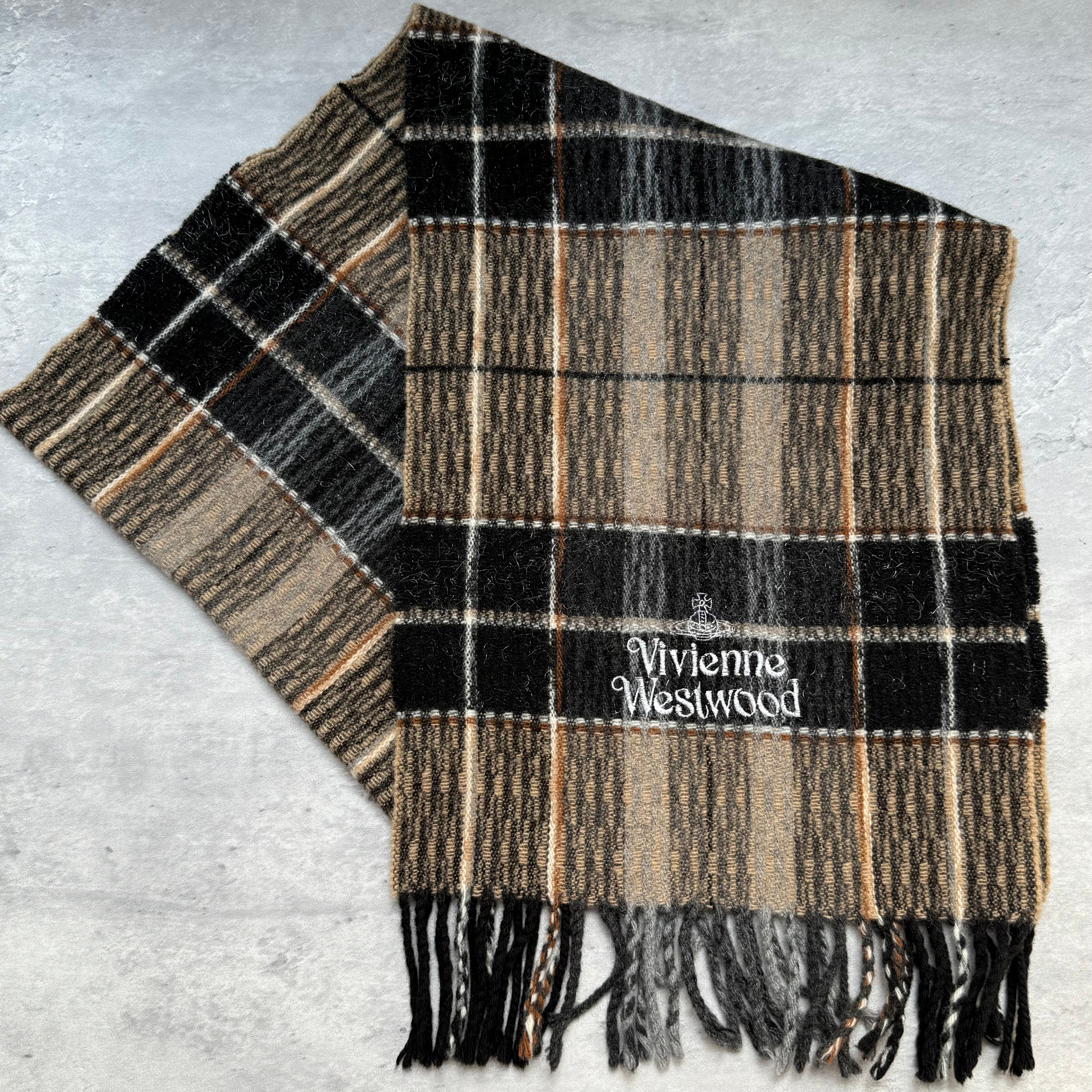 Vivienne Westwood tartan check wool scarf in beige, black, and brown with embroidered logo and fringed edges.