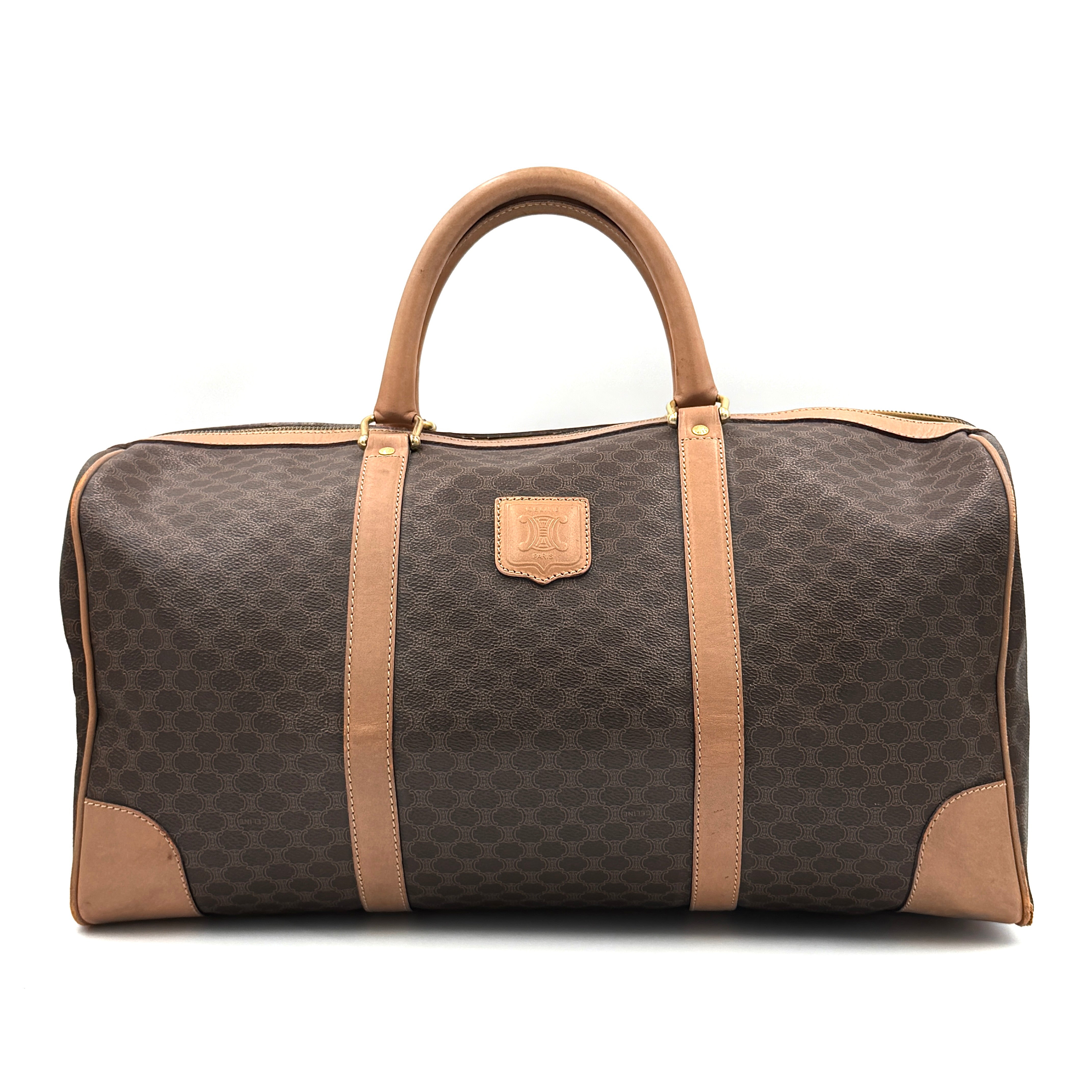 Celine Macadam Triomphe duffle bag in beige and brown monogram canvas with natural leather trim and gold-tone hardware.