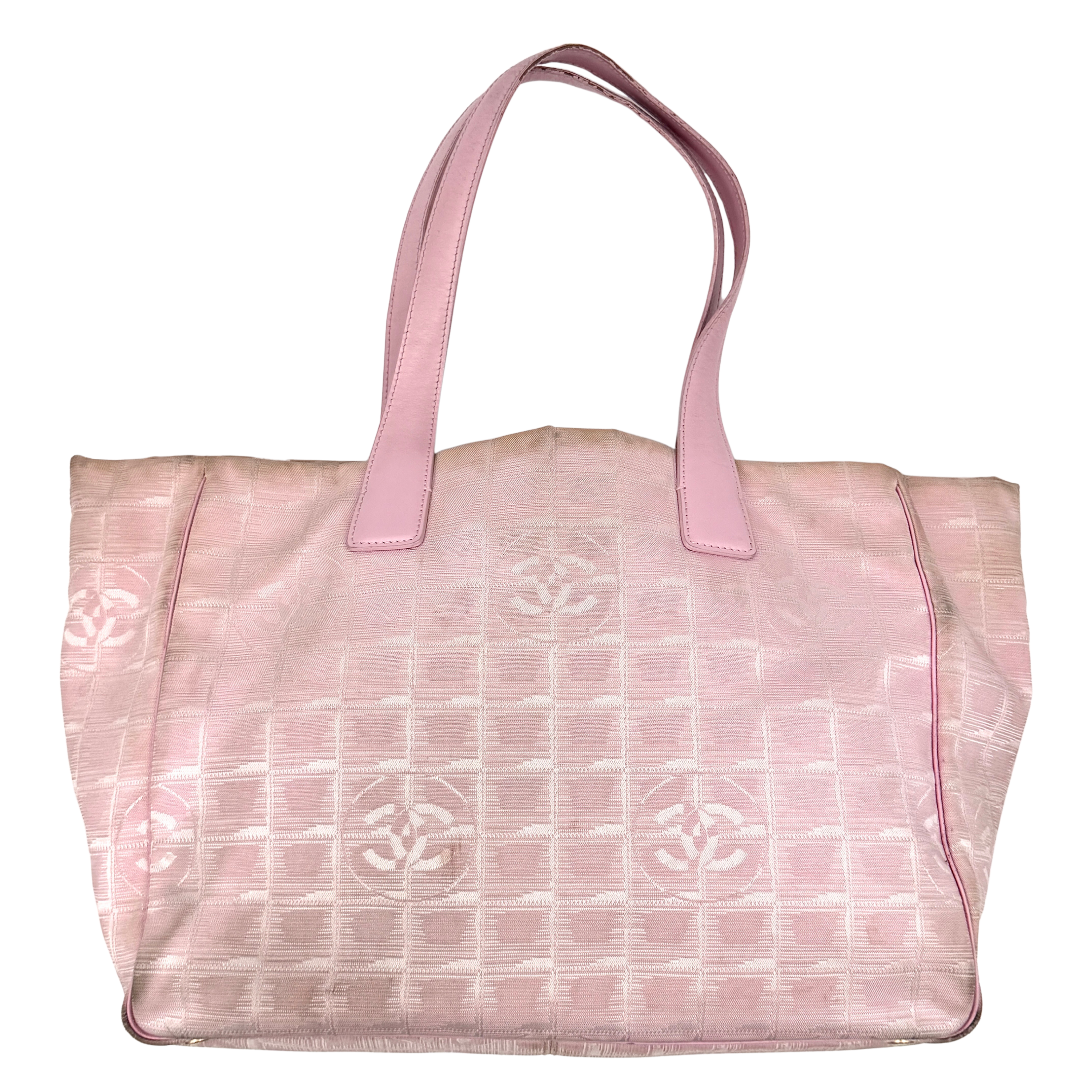 Chanel Travel Line tote bag in light pink nylon with woven grid and CC motifs, shown from front and side angles with pink shoulder straps.