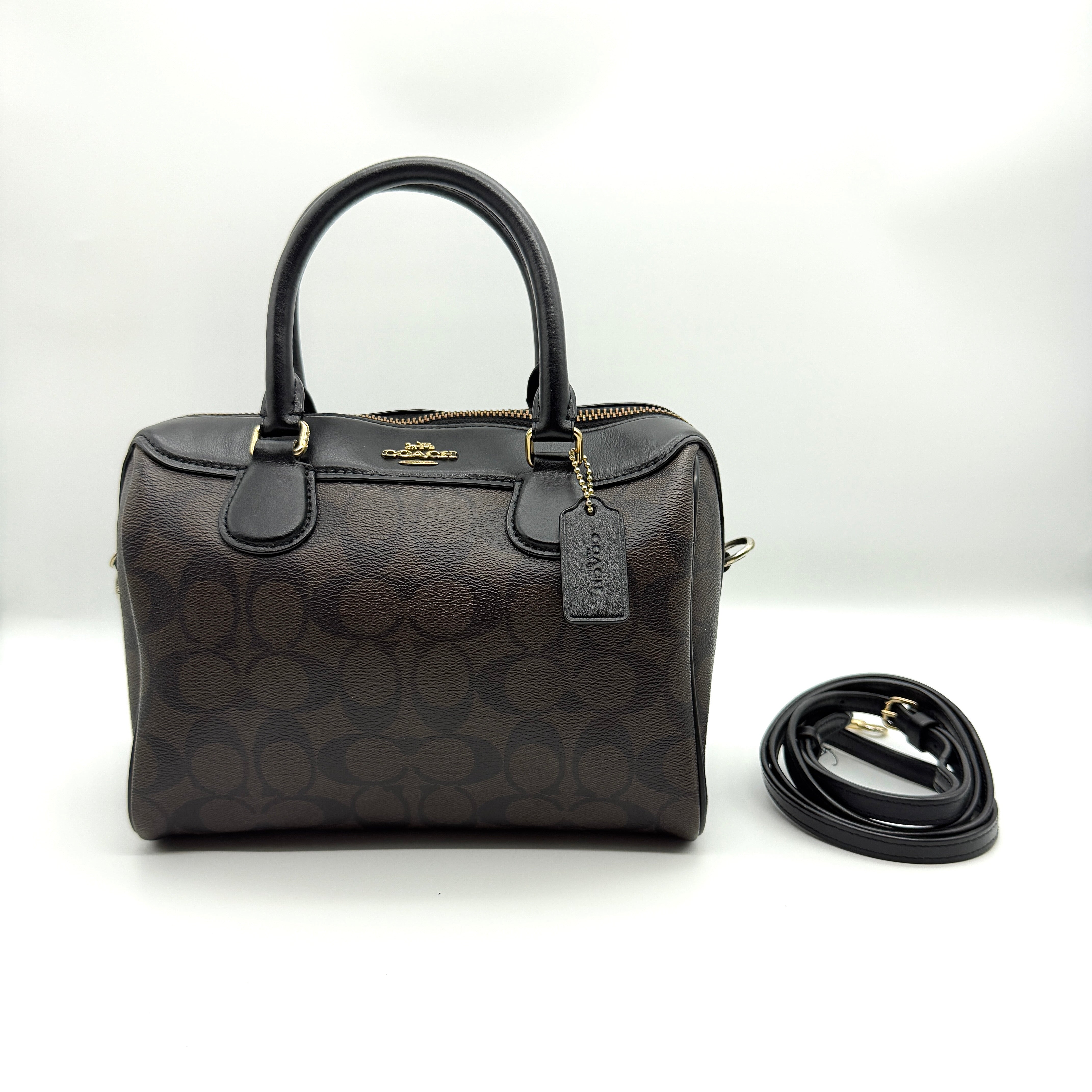 Coach 2-Way Signature PVC Mini Bennet Boston Bag in Brown and Black with gold-tone hardware and detachable strap.