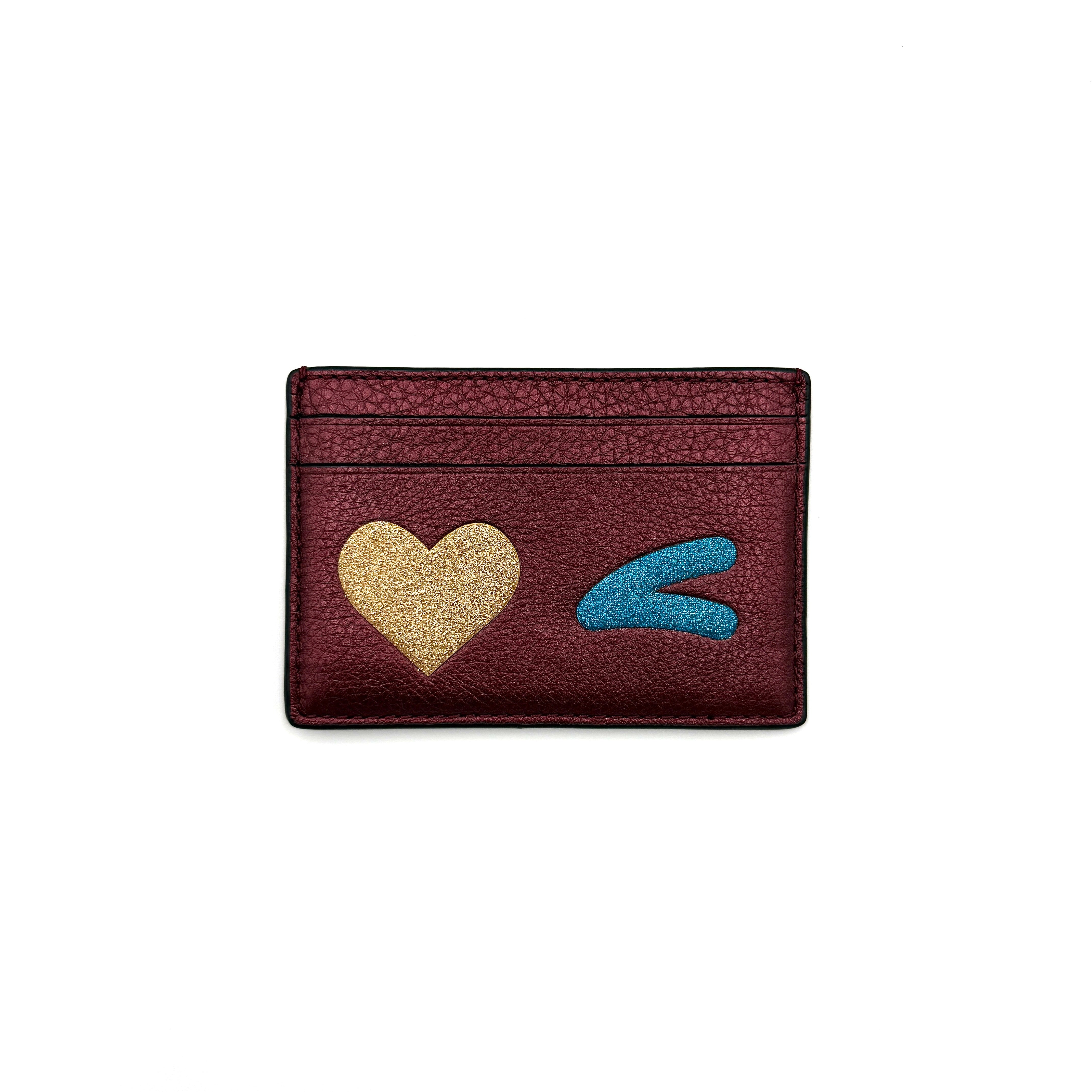 Coach burgundy cardholder with glitter heart design and compact shape