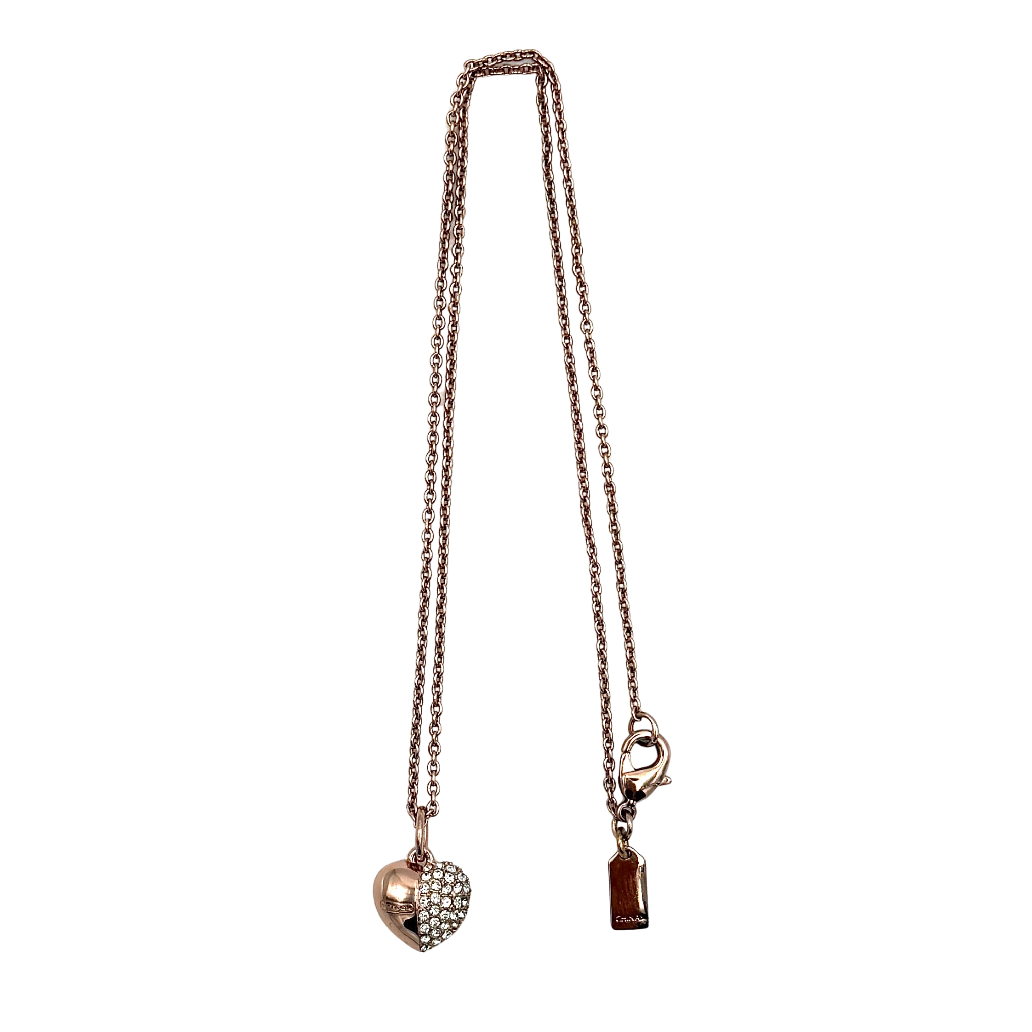 Coach heart rhinestone necklace in rose gold tone featuring a sparkling heart pendant, Coach tag charm, fine chain, and lobster clasp closure.