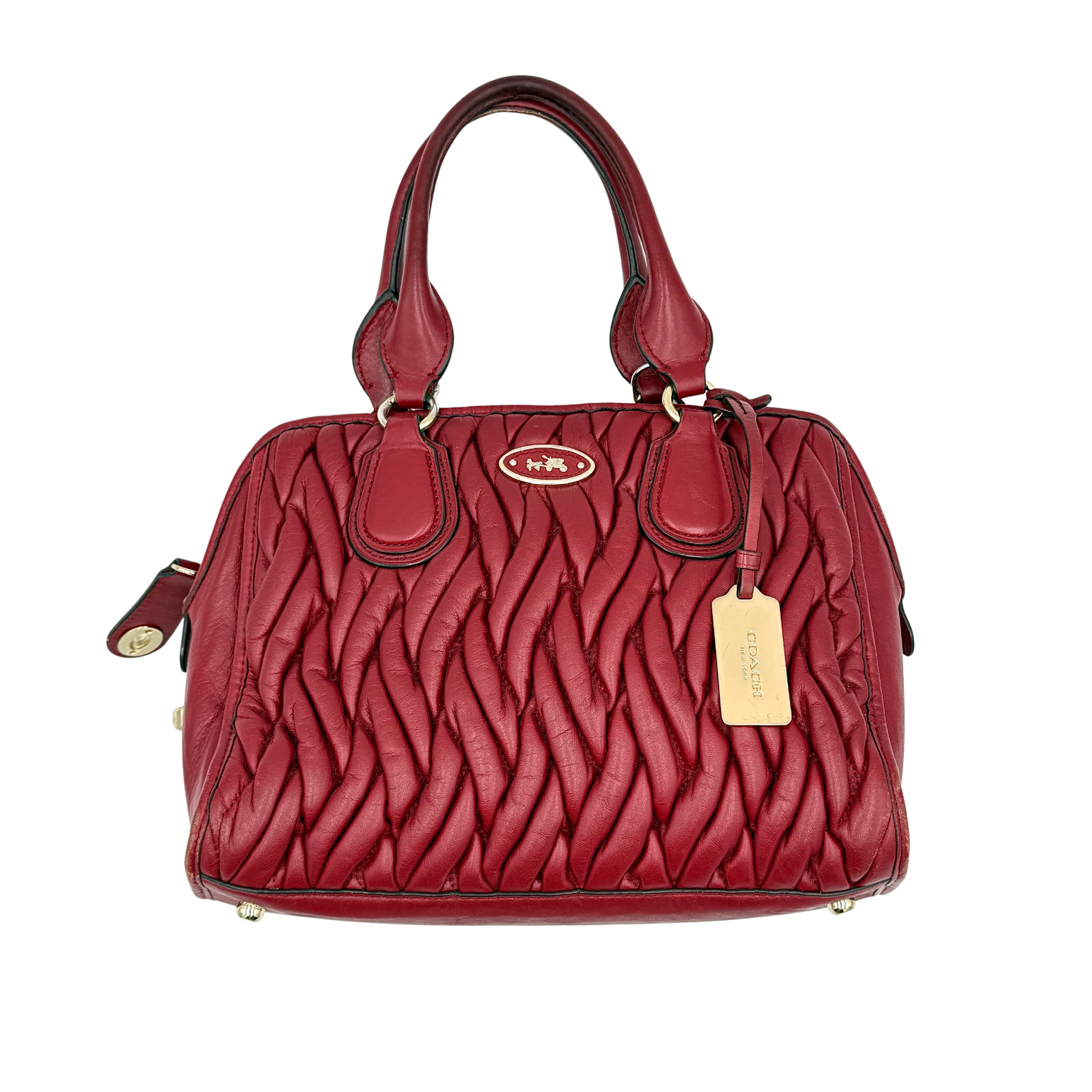Coach Nolita red handbag with quilted matelasse design and structured silhouette, featuring dual handles and elegant style
