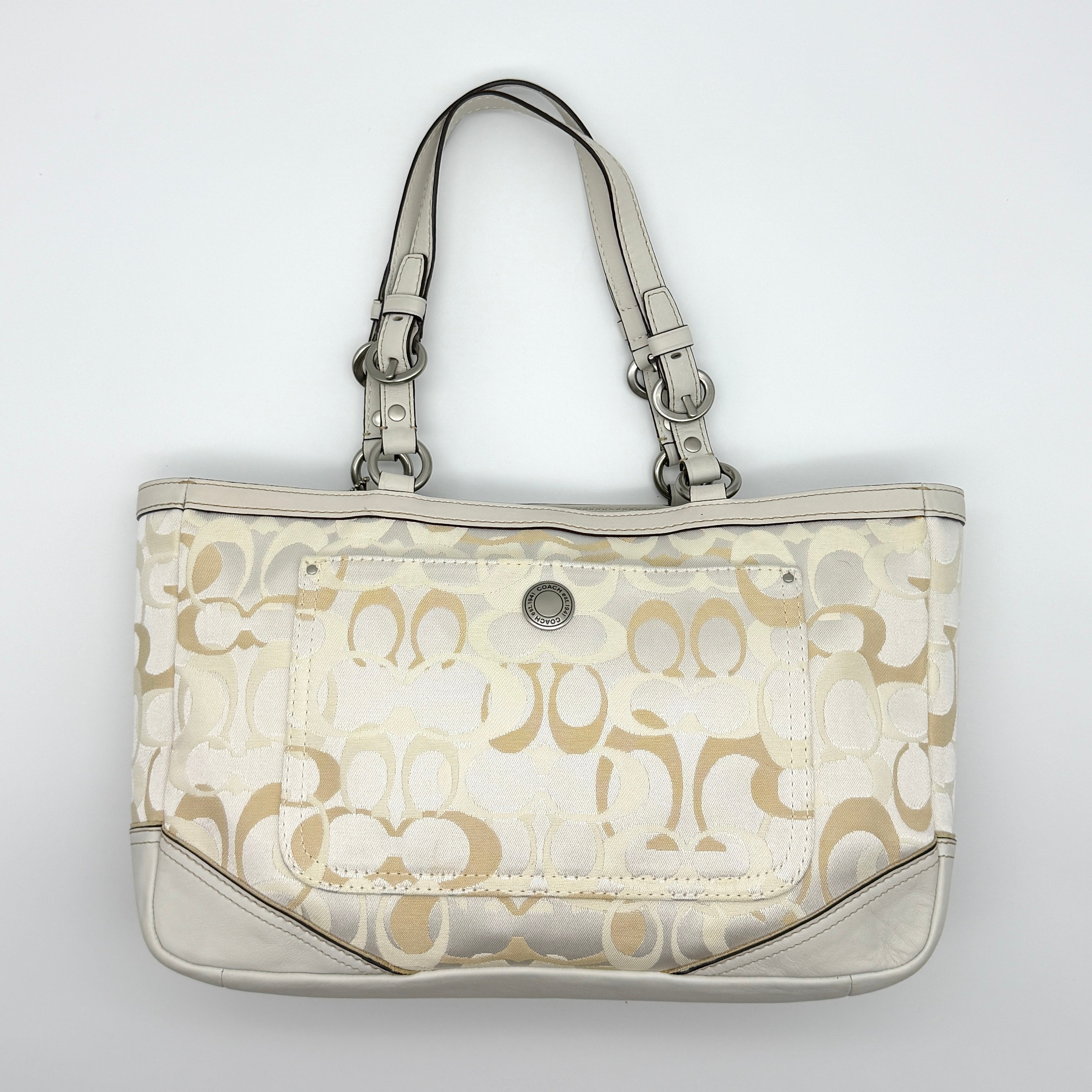 Coach Signature Canvas Tote Preloved Luxury Bag in White/Beige with pink floral heart keychain and silver-tone hardware.