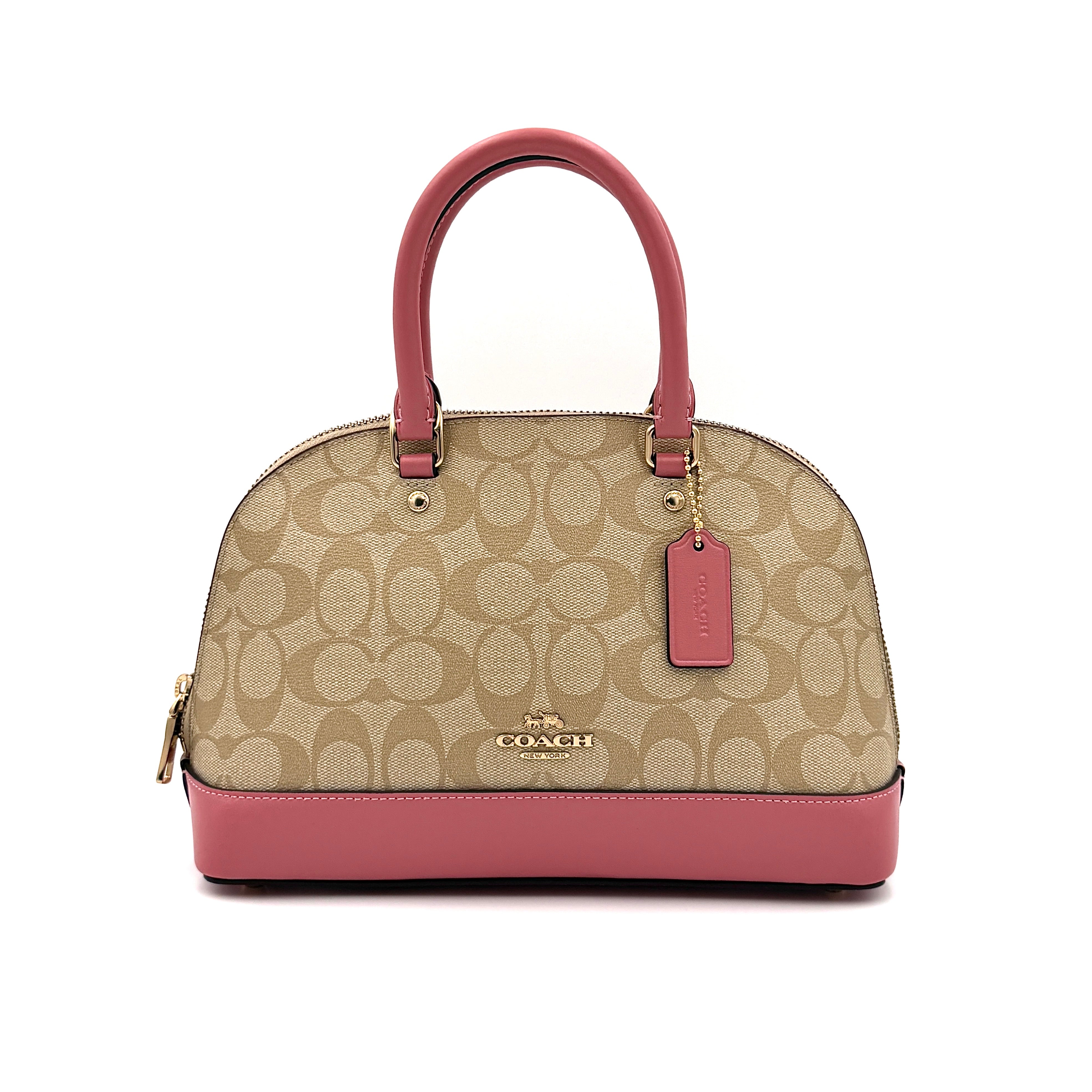 Coach signature canvas dome shoulder bag in beige with pink leather trim and gold-tone hardware.