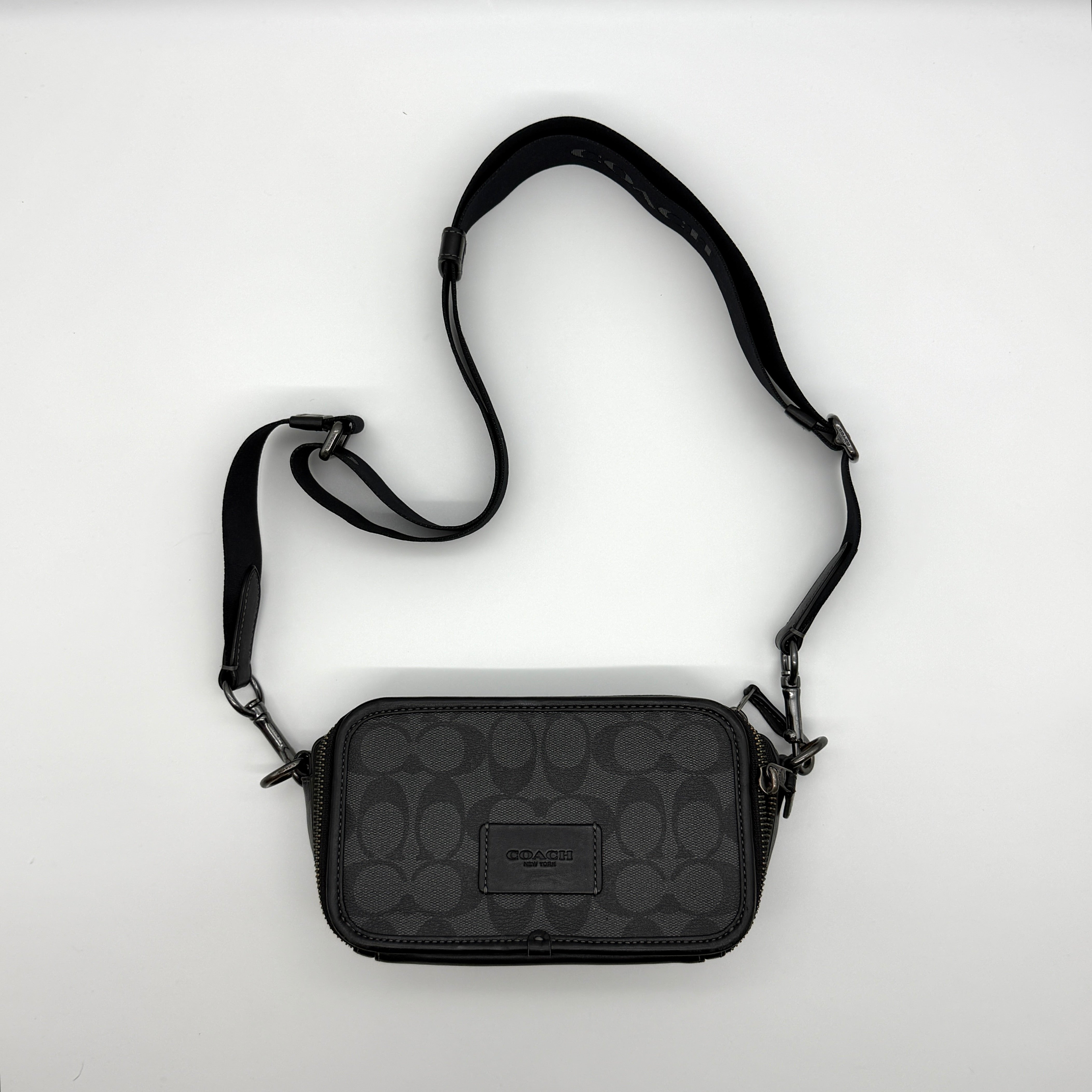 Coach Signature Graham Crossbody Bag in Black/Grey, crafted from signature coated canvas with black leather trim and gunmetal hardware.