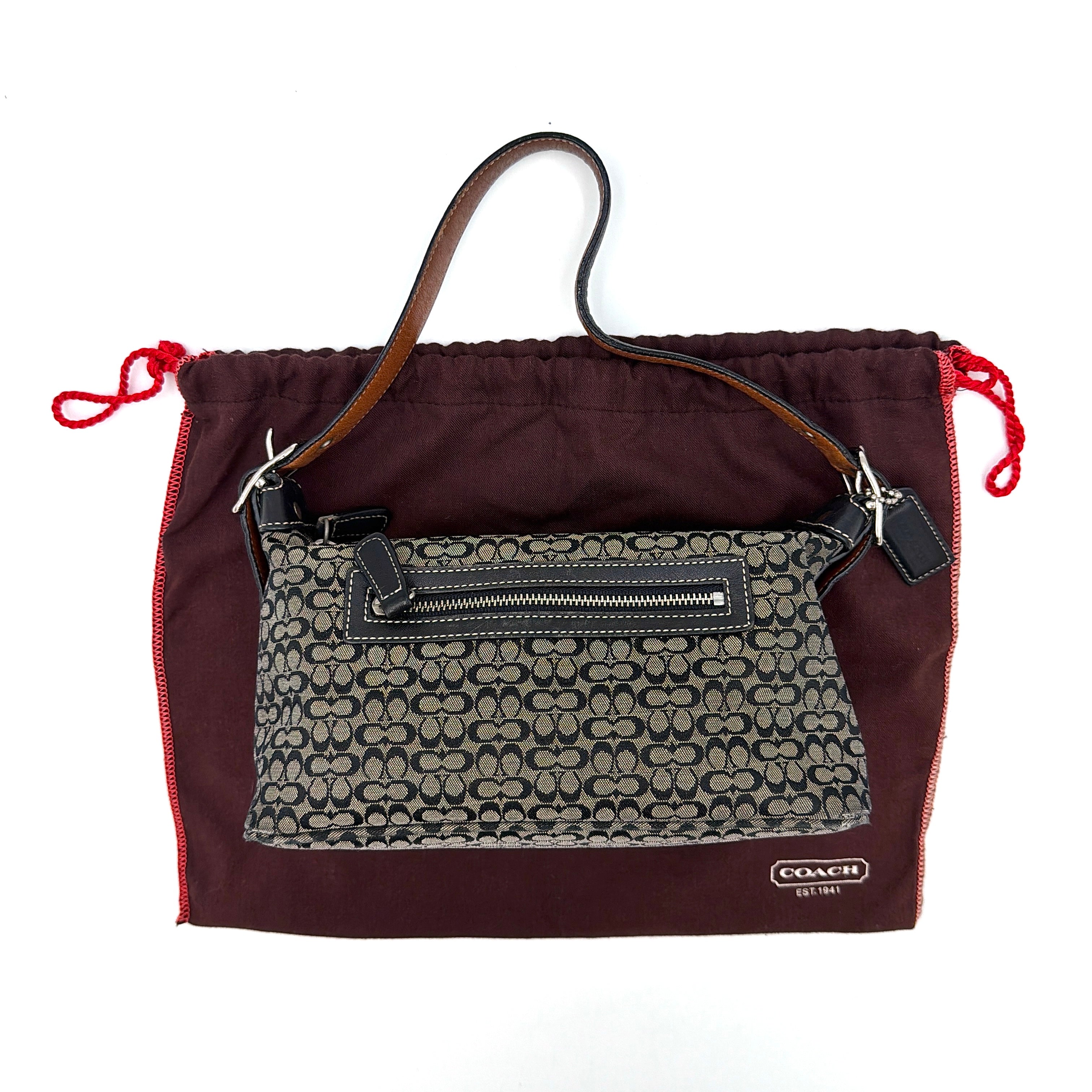Coach Signature Hobo Shoulder Bag in grey and black, featuring signature pattern and a zip closure with leather strap.