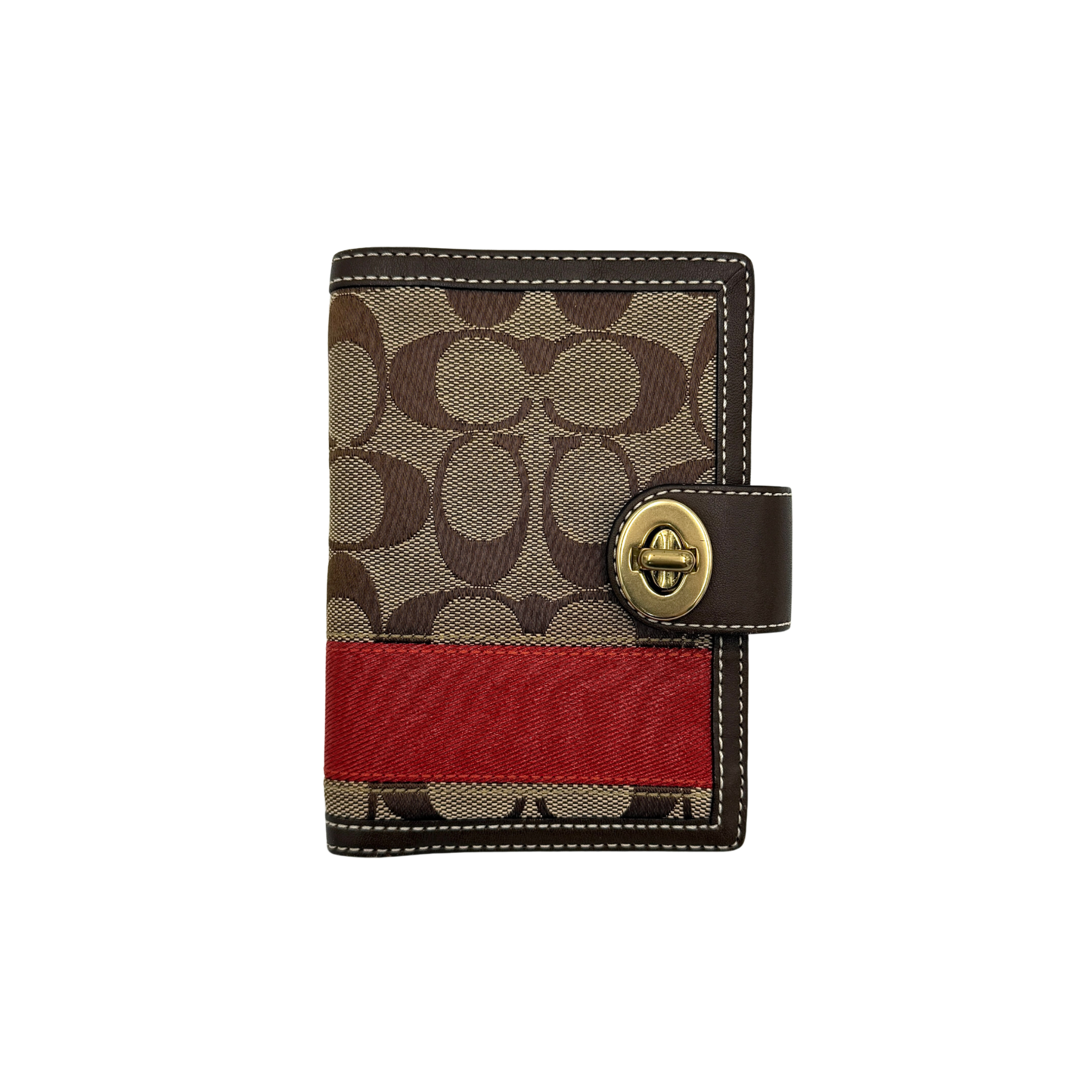Coach passport holder with signature stripe and turnlock closure, featuring red and beige colors and a spacious interior for organization.