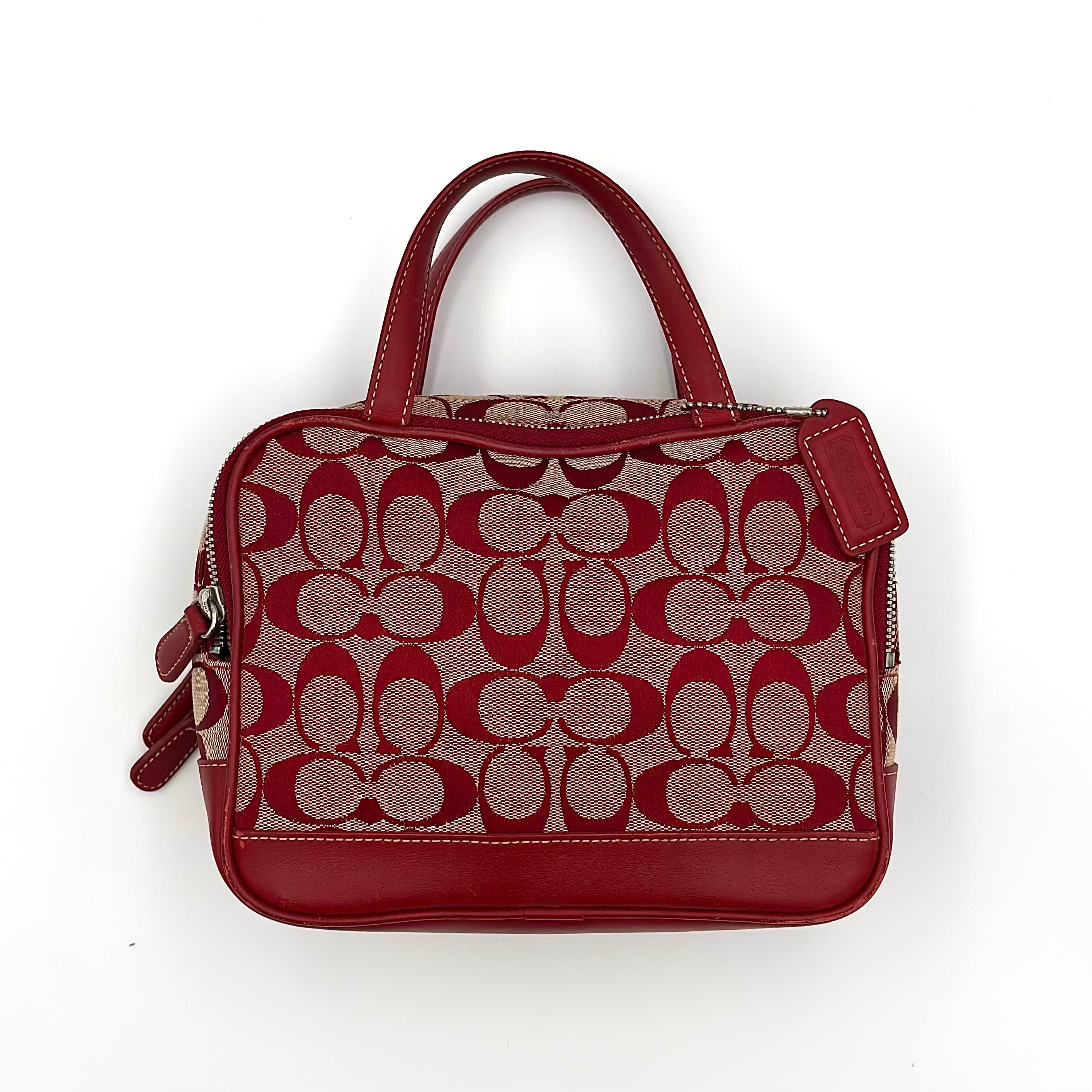 Coach Y2K Signature Canvas Mini Bag in red with leather trim, silver-tone hardware, top handles, and zippered main compartment.