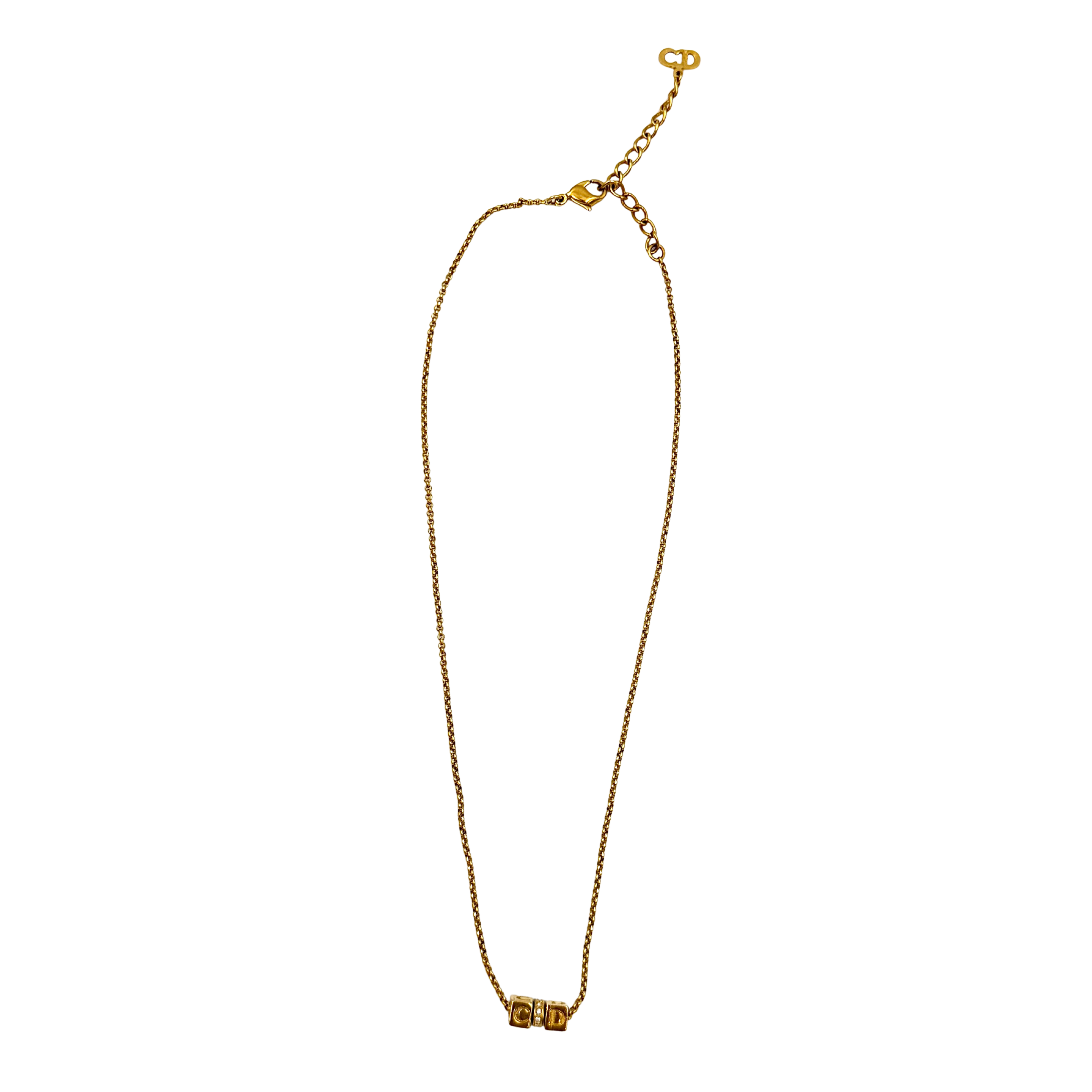 Dior CD cube crystal necklace in gold-tone metal with fine chain, lobster clasp, and extender, shown in close-up detail.