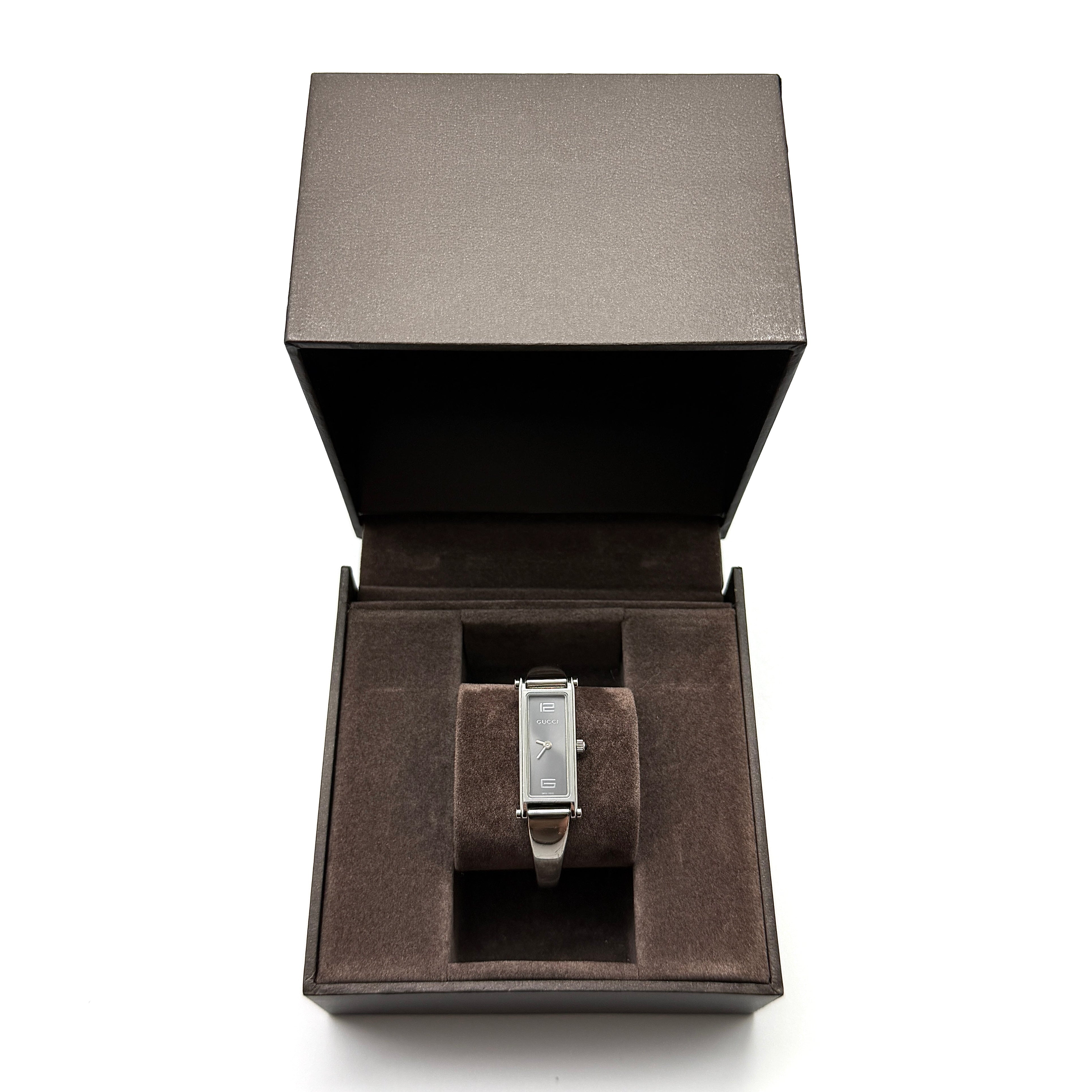 Gucci 1500L Grey Dial Watch, silver-tone stainless steel bracelet with rectangular grey dial, displayed with Gucci box.
